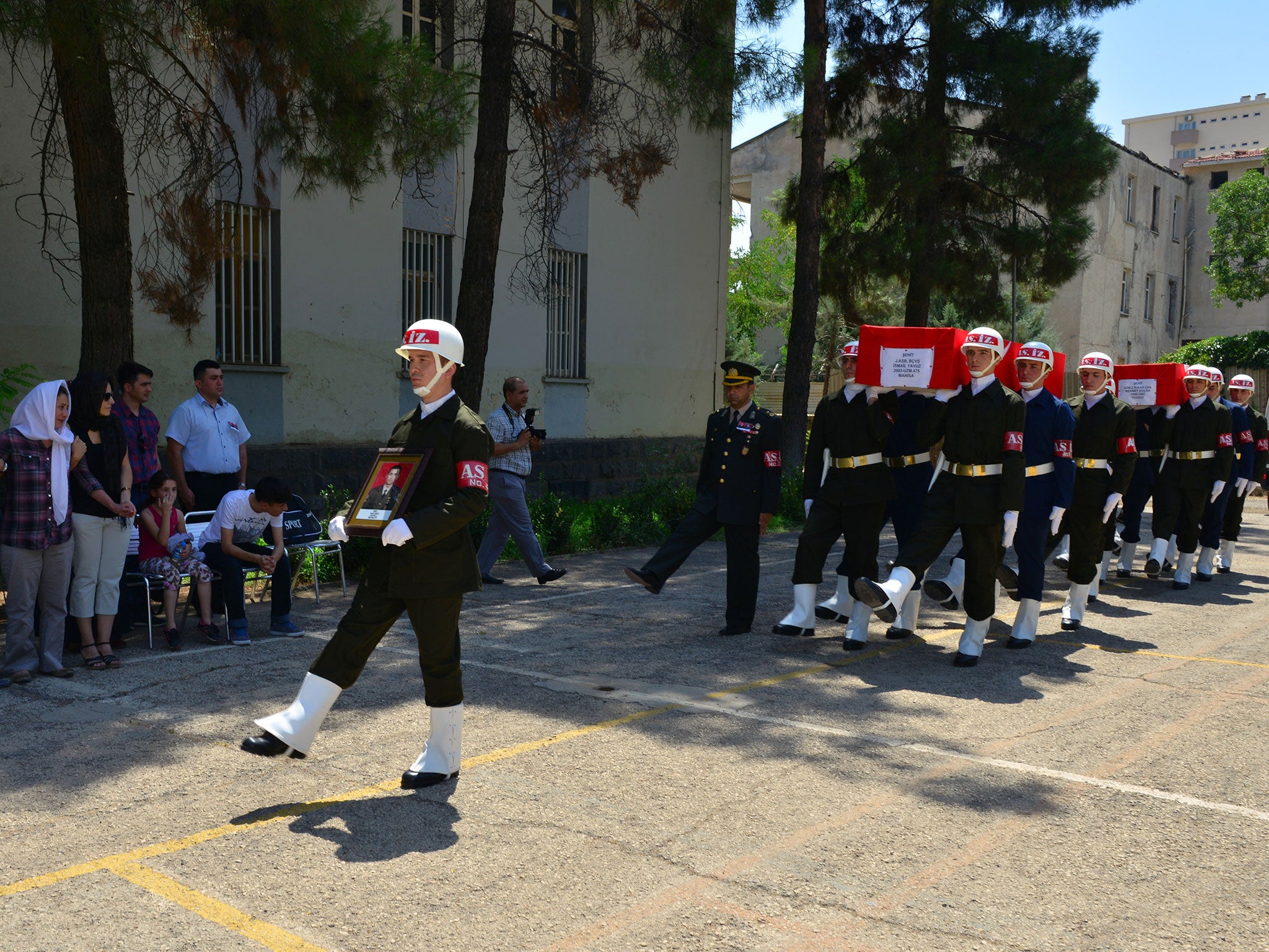 Turkish soldiers carry the coffin of a colleague killed by a car bomb planted by Kurdish militants in Diyarbakir, south-eastern Turkey, yesterday. Two troops were killed in the attack and four wounded