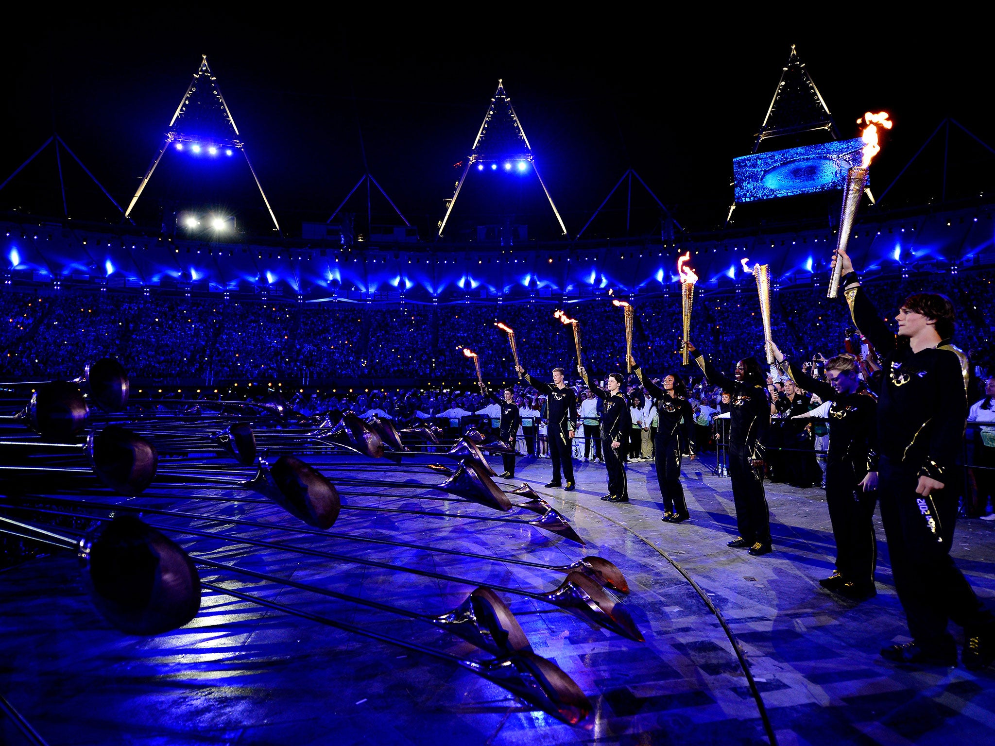 The seven cauldron lighters carry their Olympic torches at London 2012