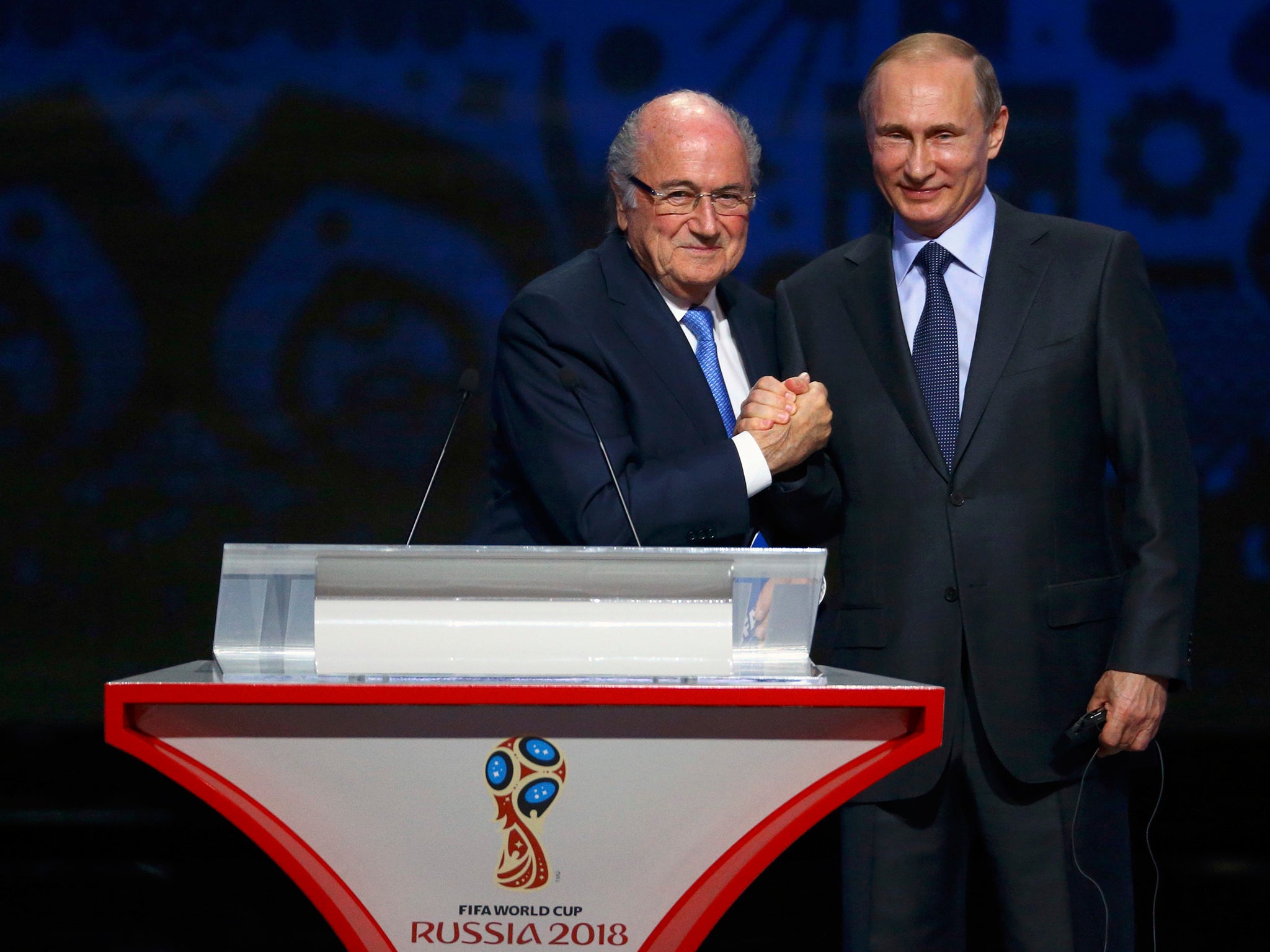 FIFA's President Sepp Blatter shakes hands with Russia's President Vladimir Putin during the preliminary draw for the 2018 FIFA World Cup at Konstantin Palace in St. Petersburg, Russia