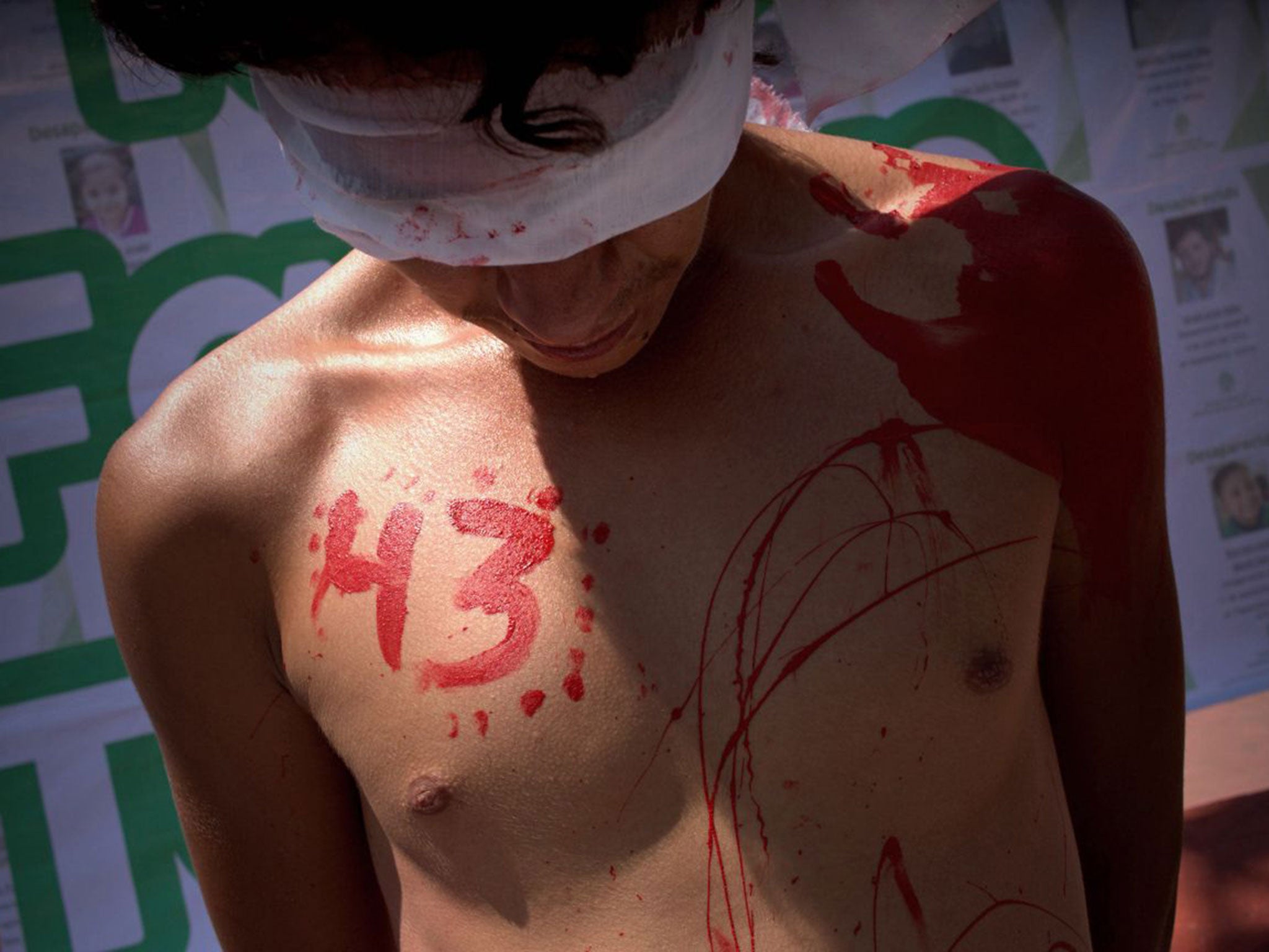 A young man protests against last year's disappearance and presumed slaughter of 43 college students during a demonstration against missing people in Guadalajara