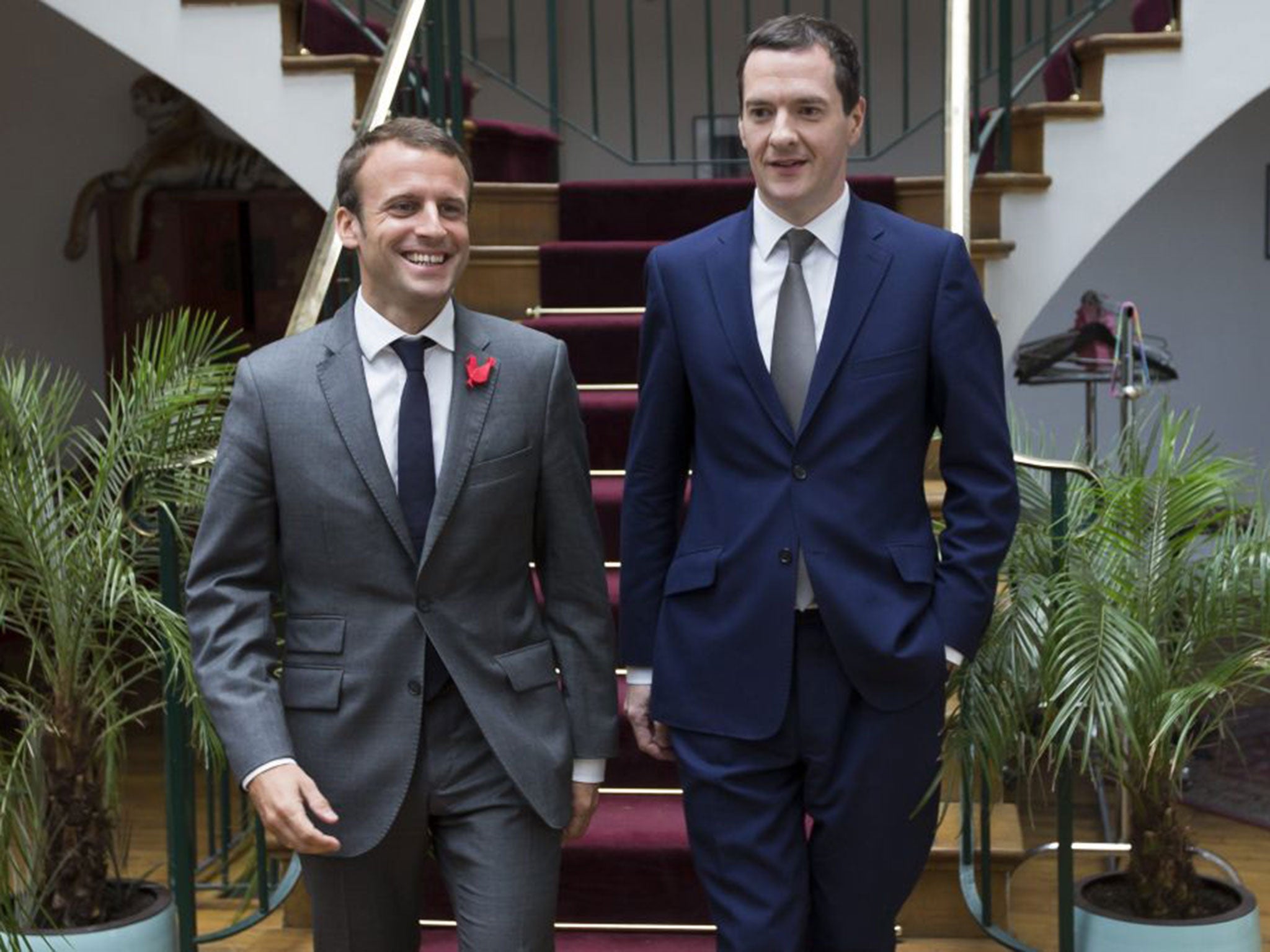 Osborne and Macron talk as they are shown around 'The Family' (EPA)