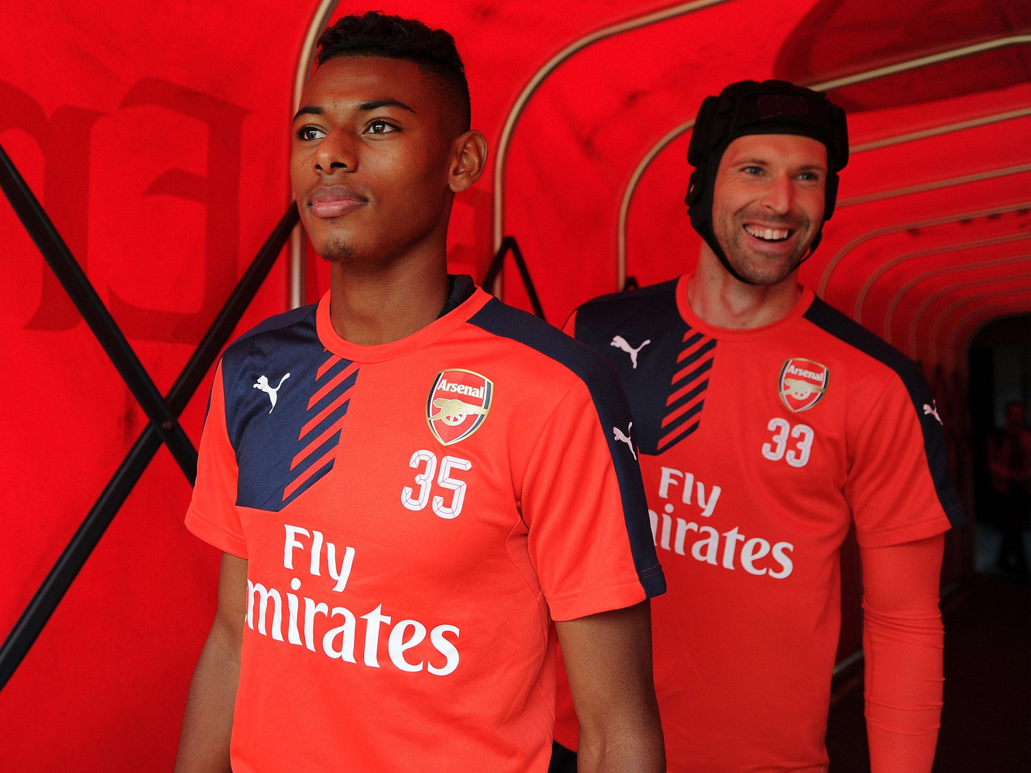 New additions to the Arsenal squad, Jeff Reine-Adalaide and Petr Cech, walk out of the tunnel at the club's open training session at the Emirates Stadium on Tuesday (Getty)