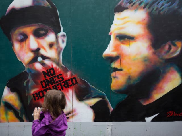 A girl passes a piece of street art as part of the ongoing Upfest 2015 festival being held in Bedminster on July 27, 2015 in Bristol, England. The three-day annual event - which started in 2008 and is said to be the largest free street art and graffiti fe