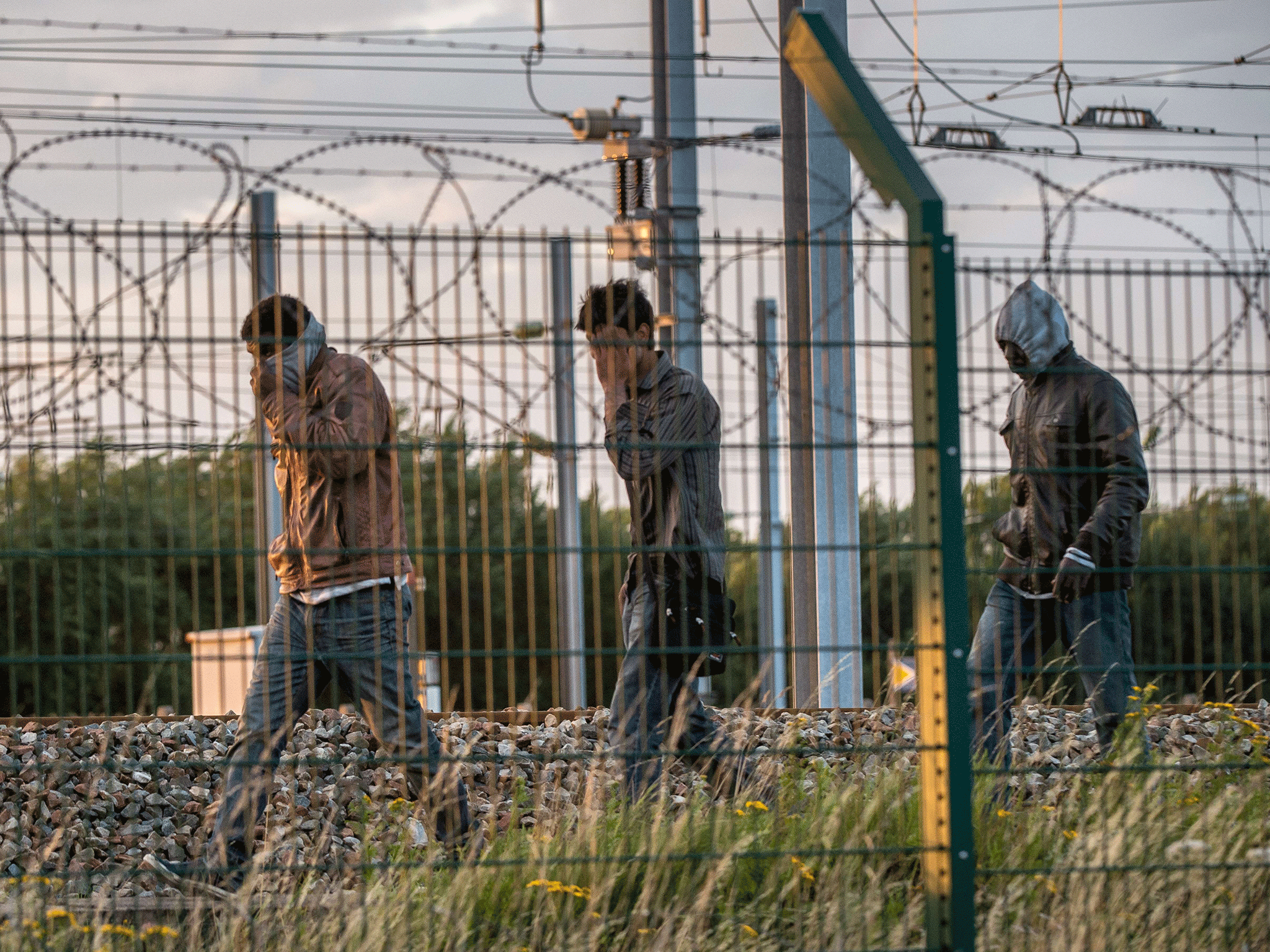 Migrants try to reach a shuttle to Great Britain, on July 28, 2015 in Frethun, northern France