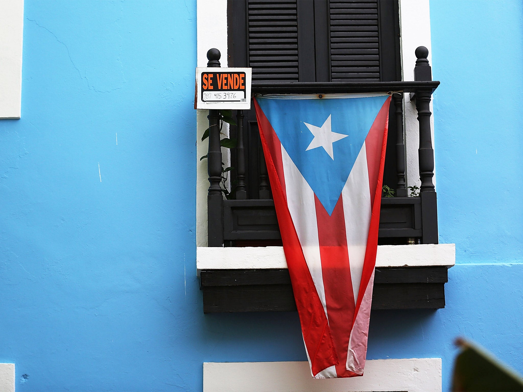 Puerto Rico has an outstanding debt of $72bn. Economists say the country should shrink the size of the state rather than default on repayments