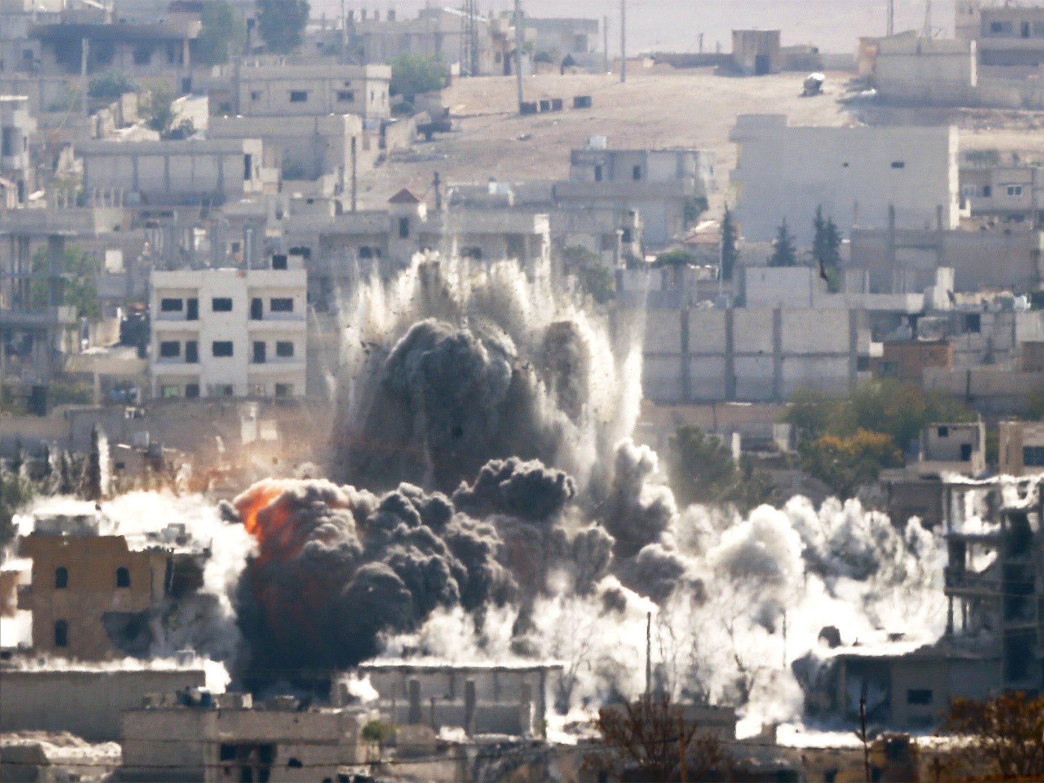 An explosion following an air-strike is seen in the Syrian town of Kobani last year