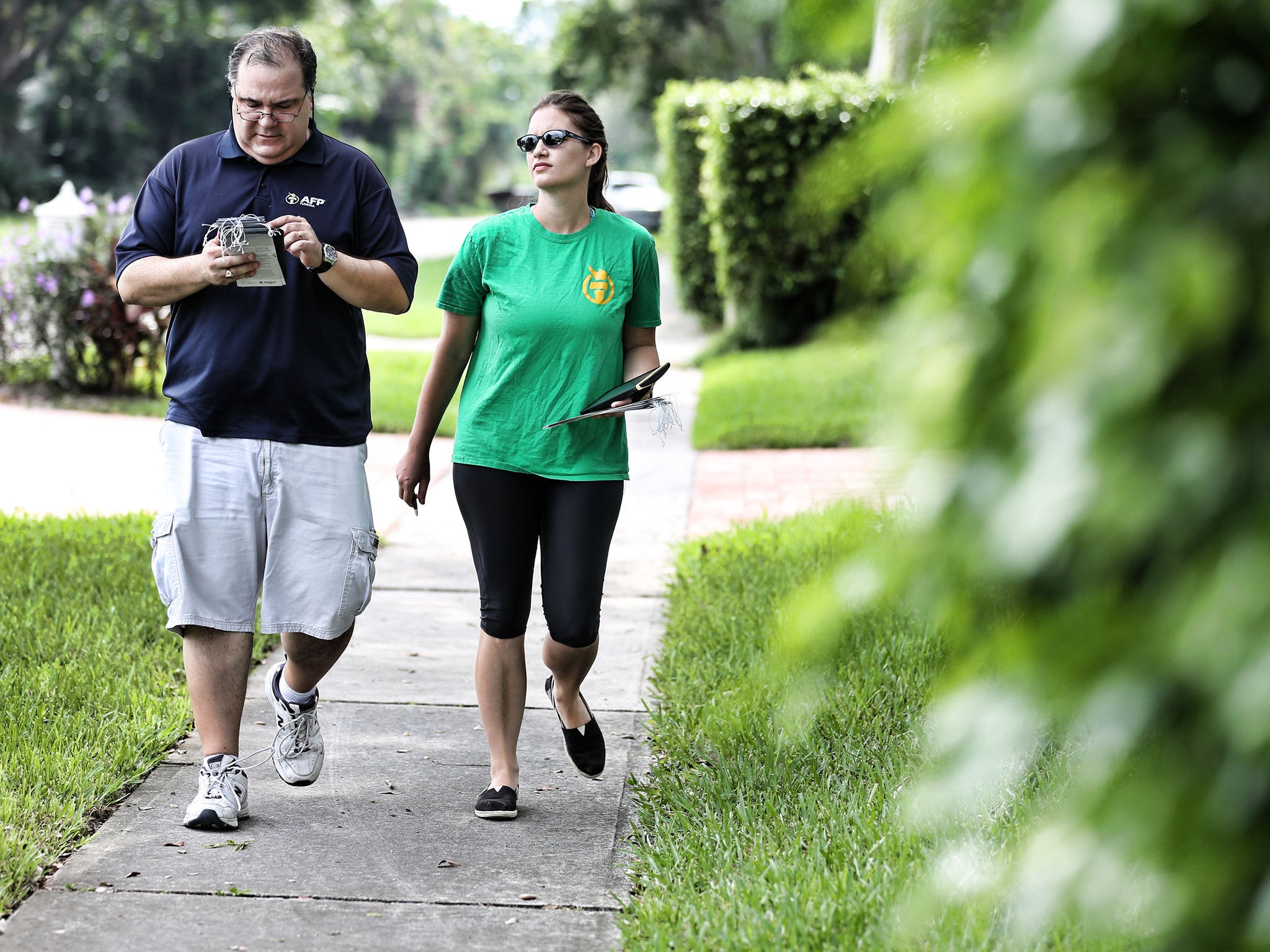 Carlos Muhletaler, a field director for the Kochs’ political network Americans for Prosperity, and canvasser Kristin Matheny on the streets of Boca Ratonon Tuesday (