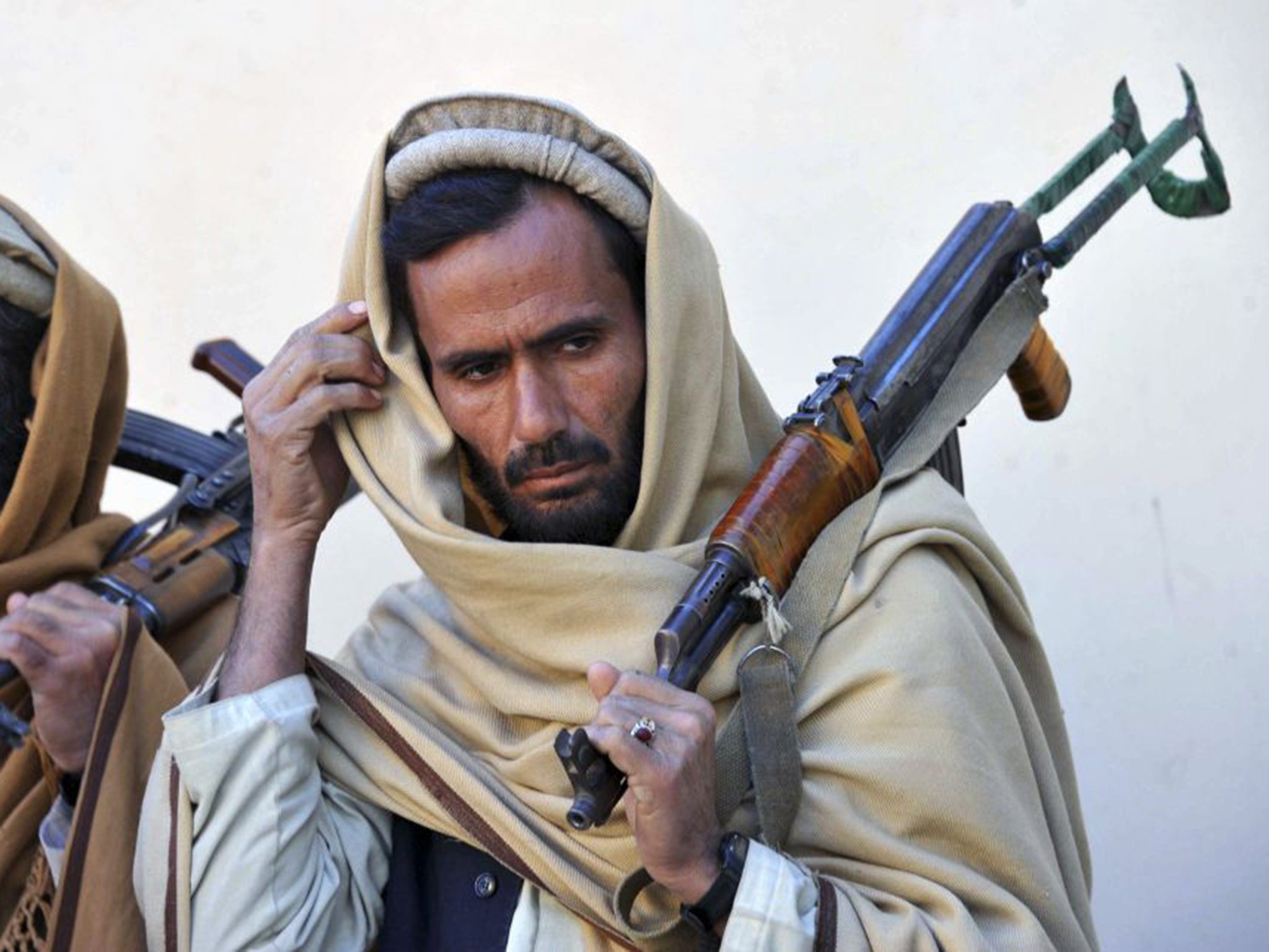 Former Taliban fighters remain well armed despite joining a peace and reconciliation process ceremony in Herat last year. Now they wait to find out if peace will be pursued