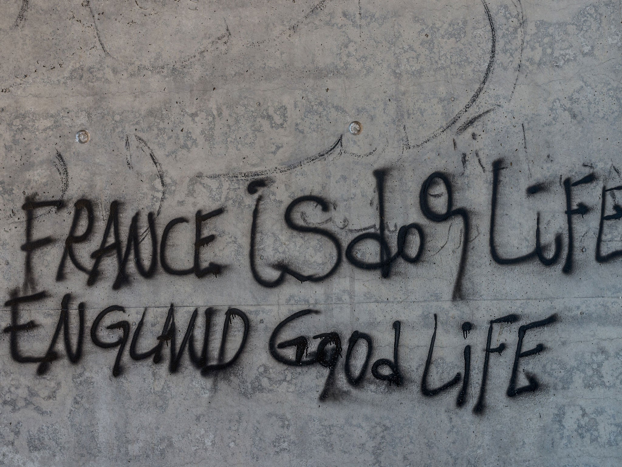 Graffiti reads 'France is dog life- England is good life'