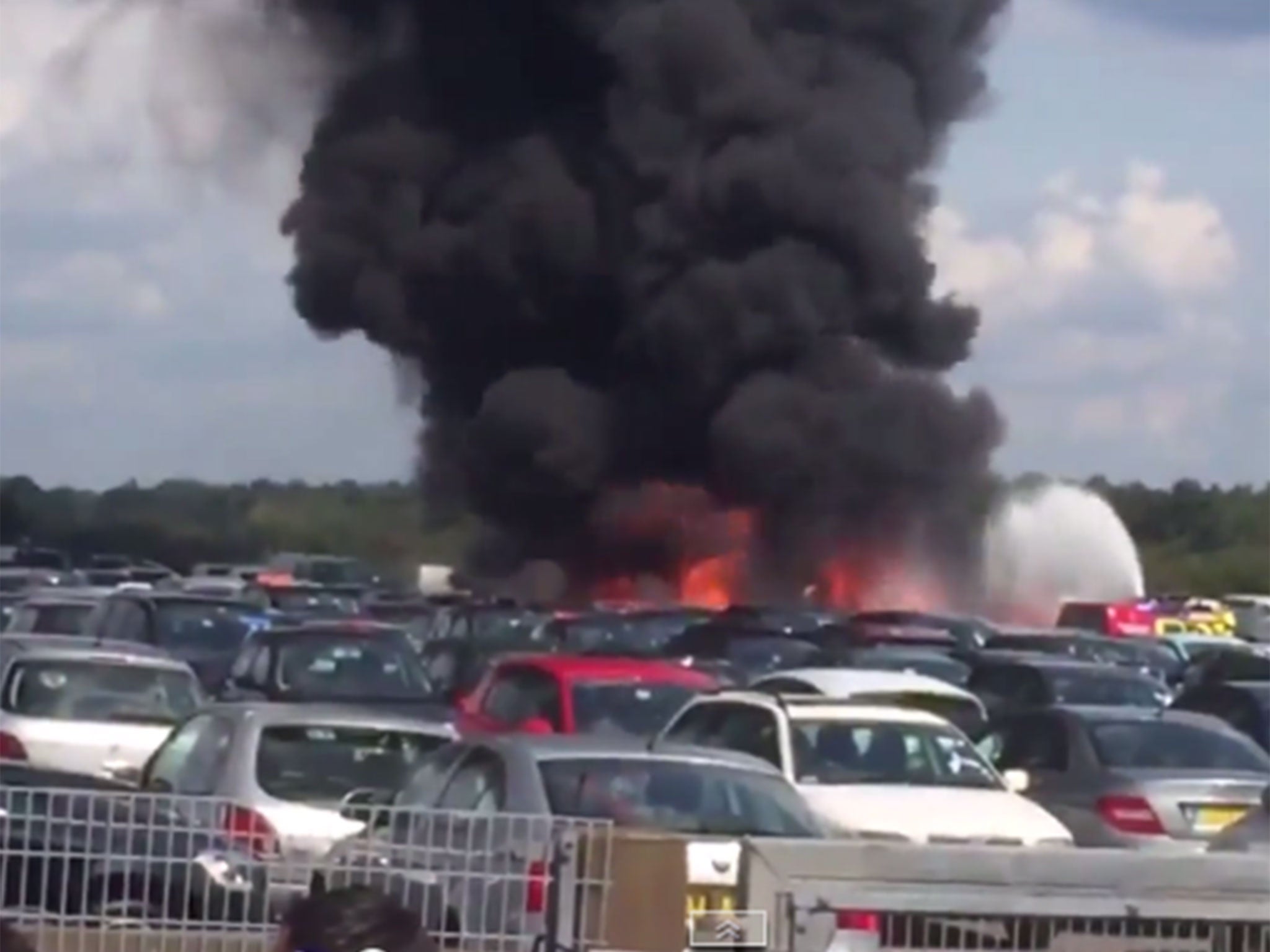 Firefighters douse a plane with water after it crashed