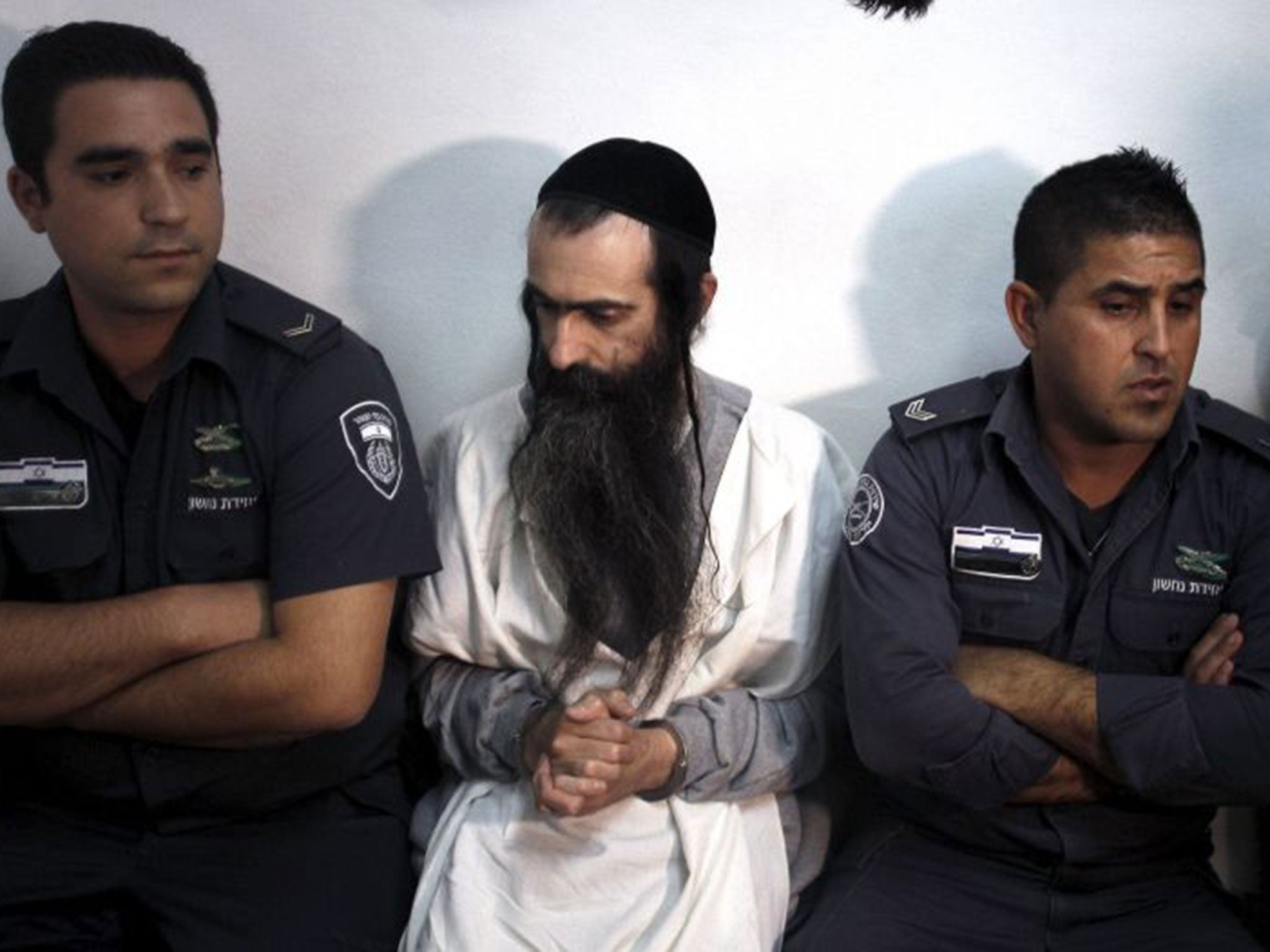 Yishai Schlissel (C) is escorted by security personnel at the Jerusalem Magistrates Court July 31, 2015