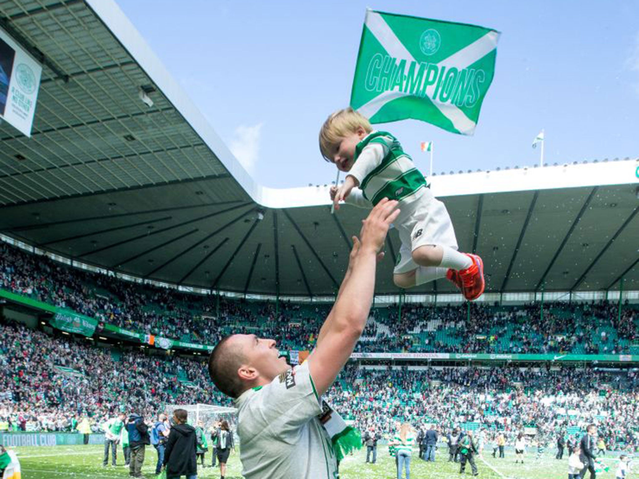 Celtic captain Scott Brown with his son Sonny after winning the Scottish Premiership Match between Celtic and Inverness Caley Thistle at Celtic Park on May 24, 2015