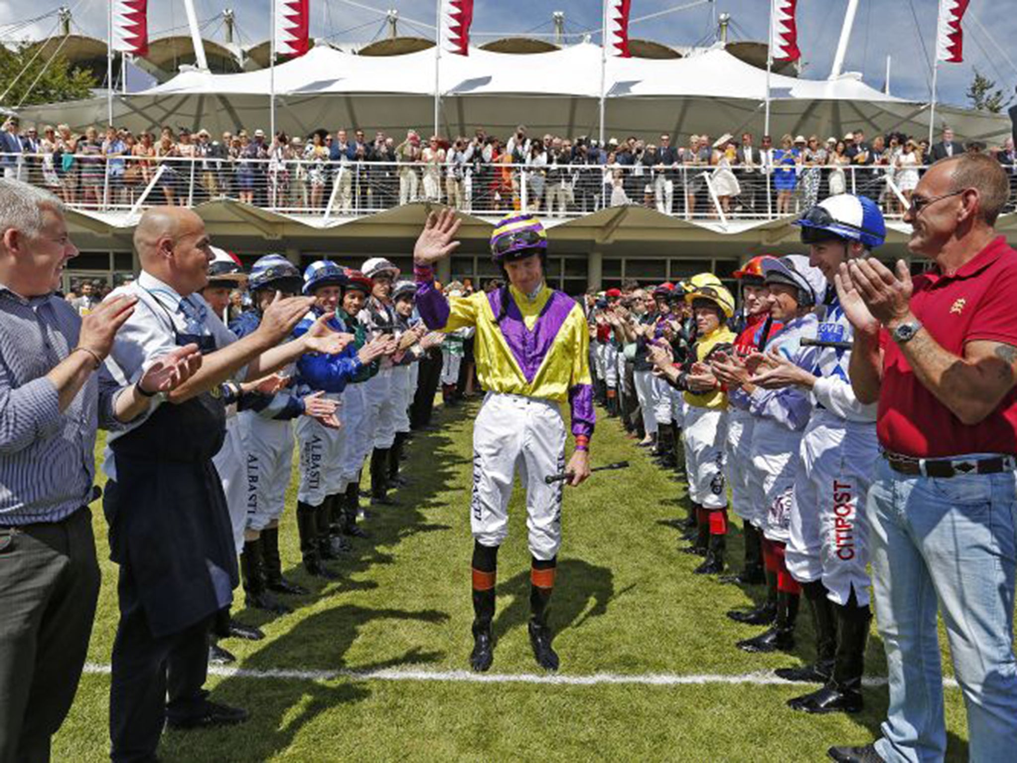 Richard Hughes waves as he walks through a guard of honour at the end of an emotional day