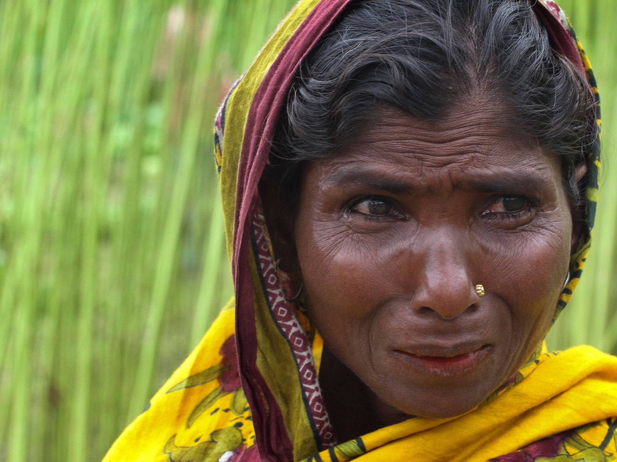 A woman weeps after Bangladesh and India officially exchanged enclaves