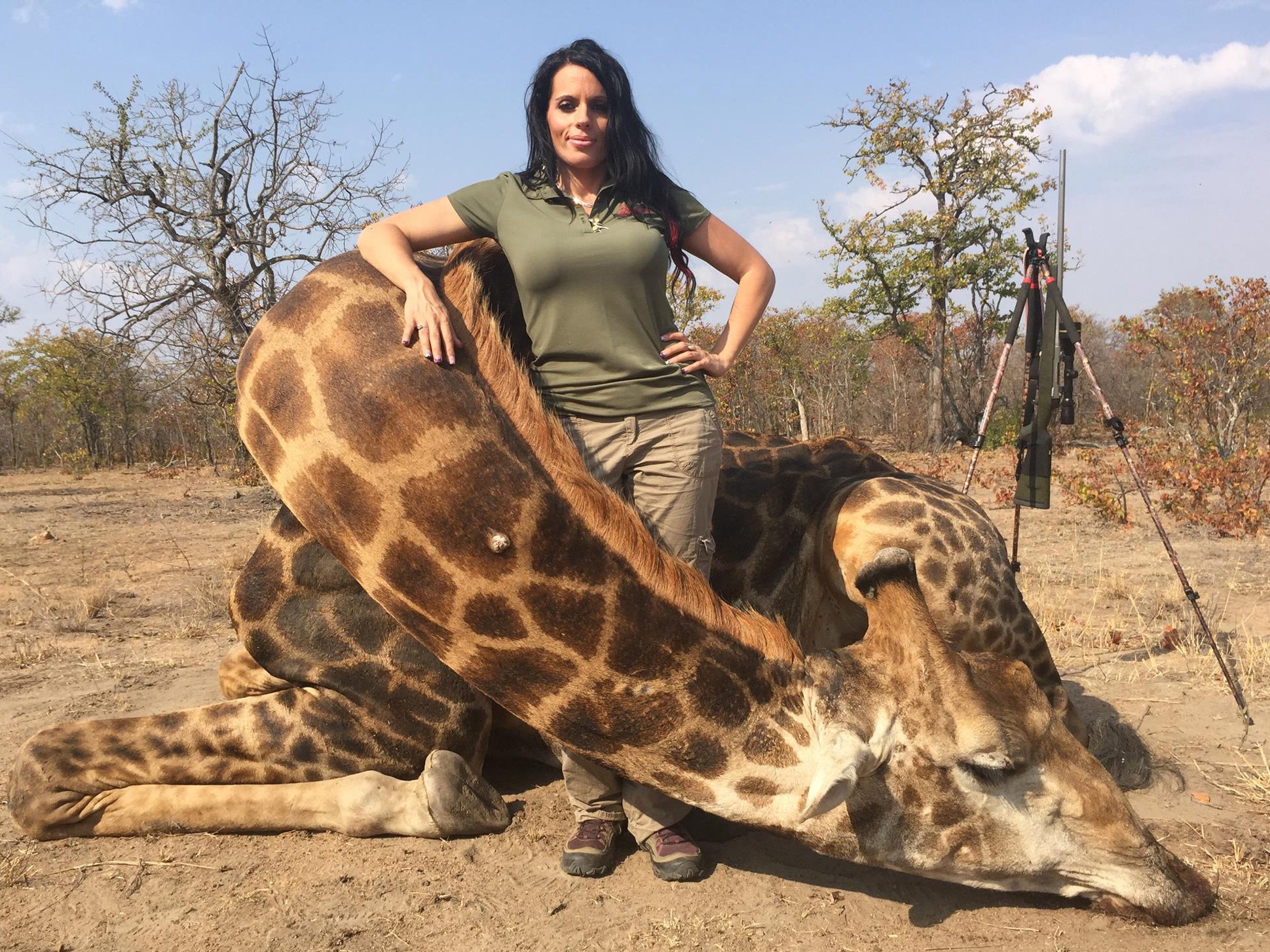 Sabrina Corgatelli poses with the body of the giraffe she killed on safari in South Africa