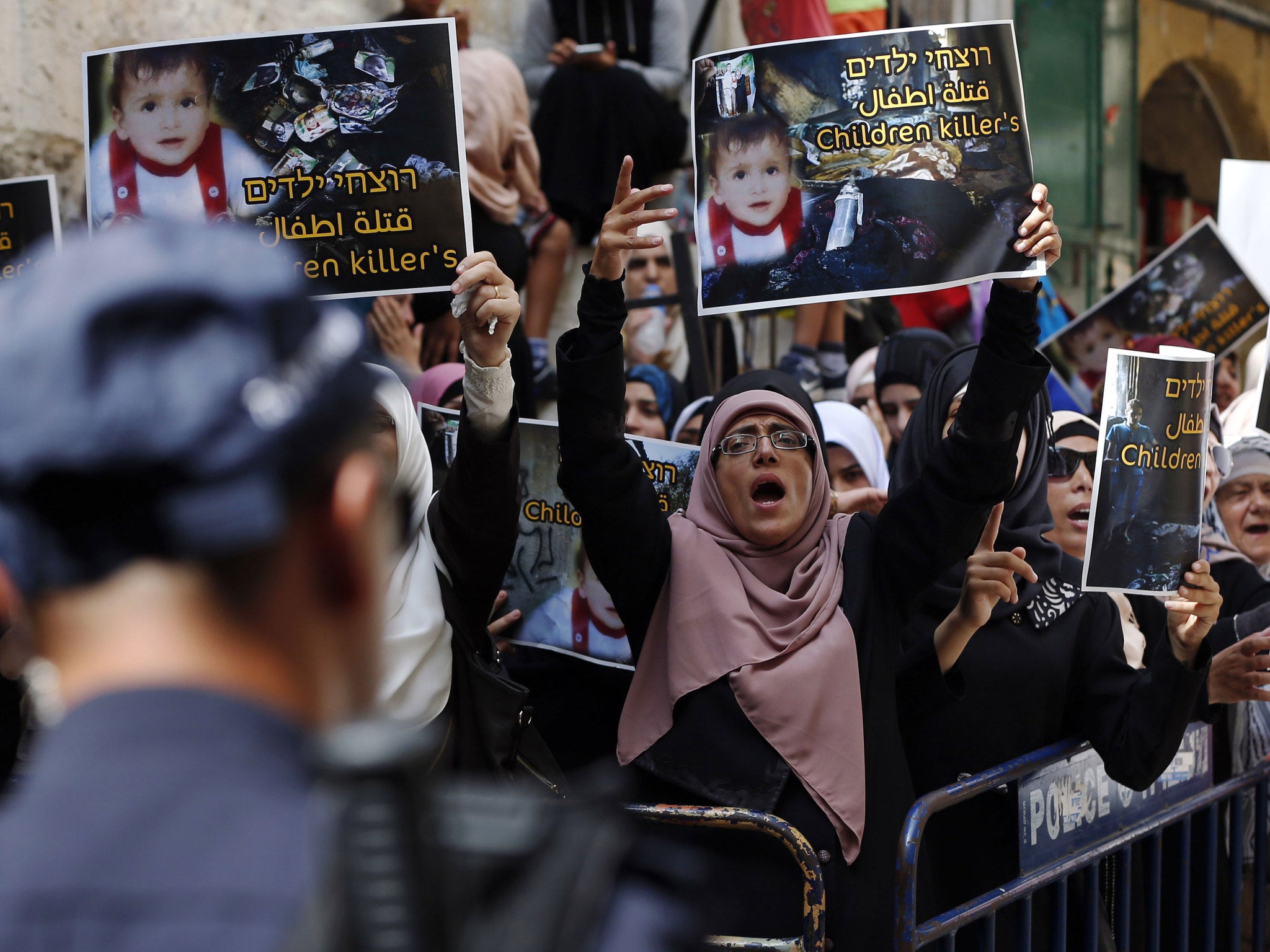 Palestinians protest against the death of the 18-month-old child killed in an arson attack in the West Bank