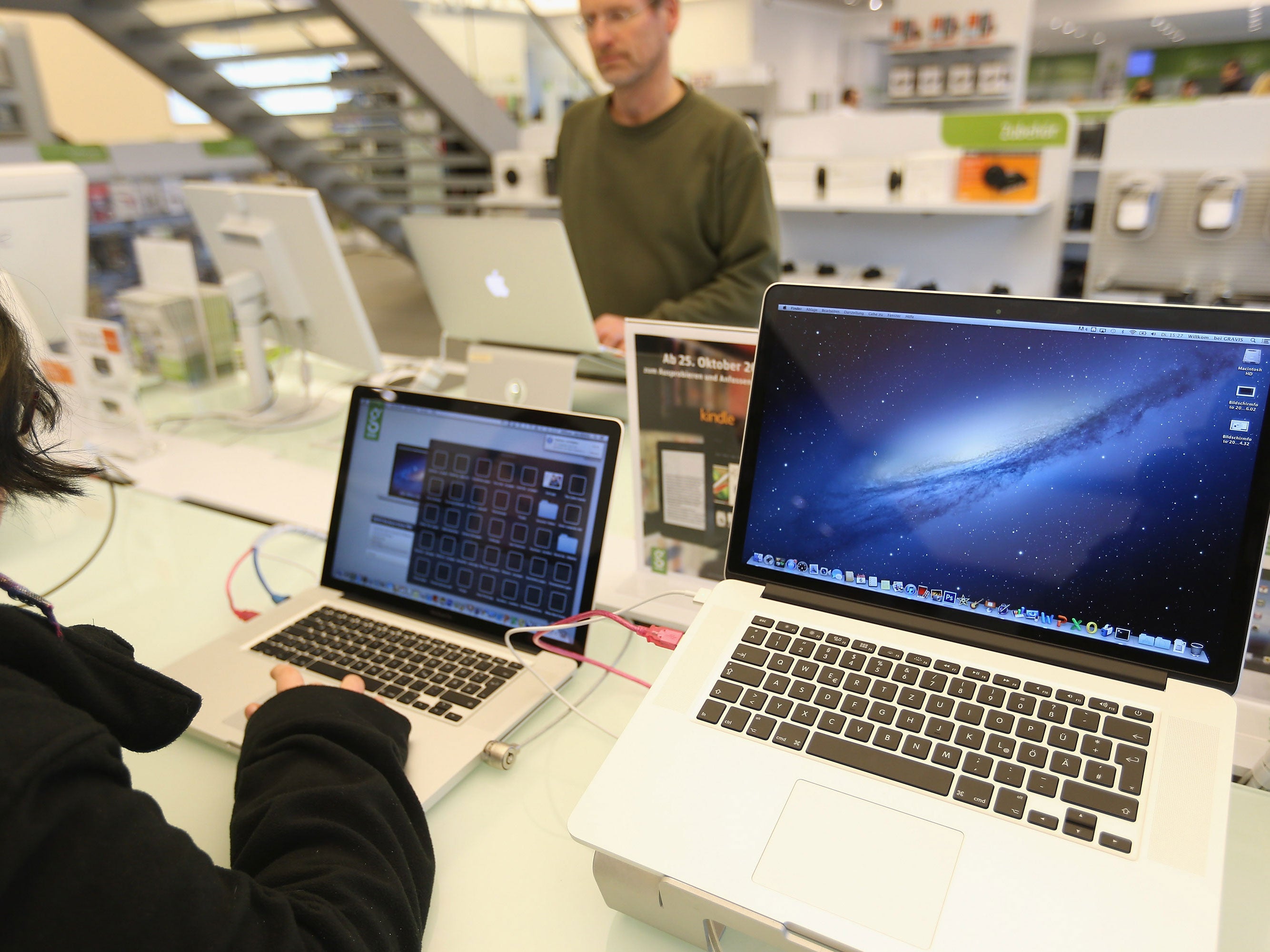 Apple MacBook Pro computers with Retina displays stand at a table at a Gravis Apple retailer on November 6, 2012 in Berlin, Germany