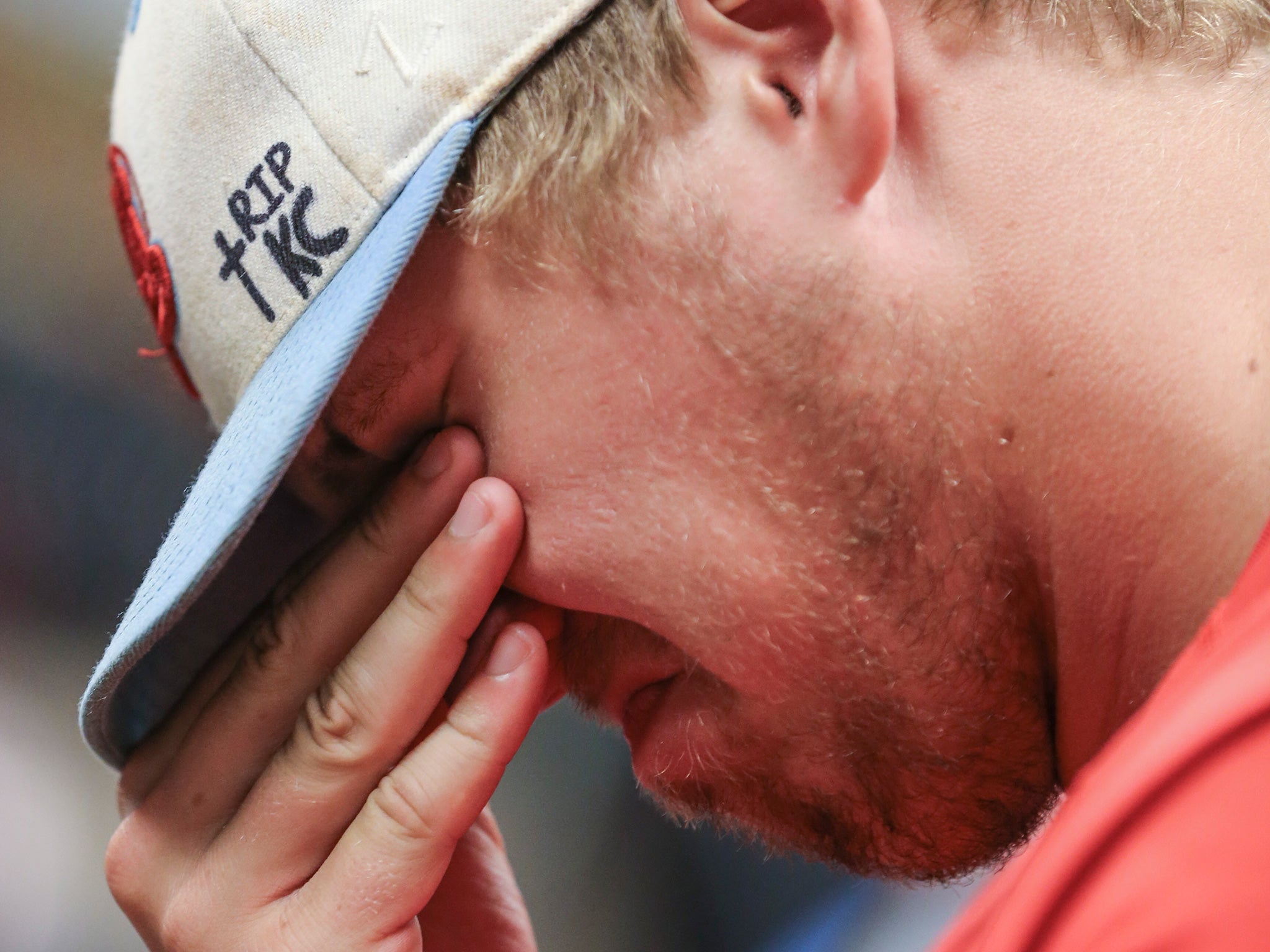 Nick Brooks, a first baseman for the Liberal Bee Jays, fights back tears during a news conference