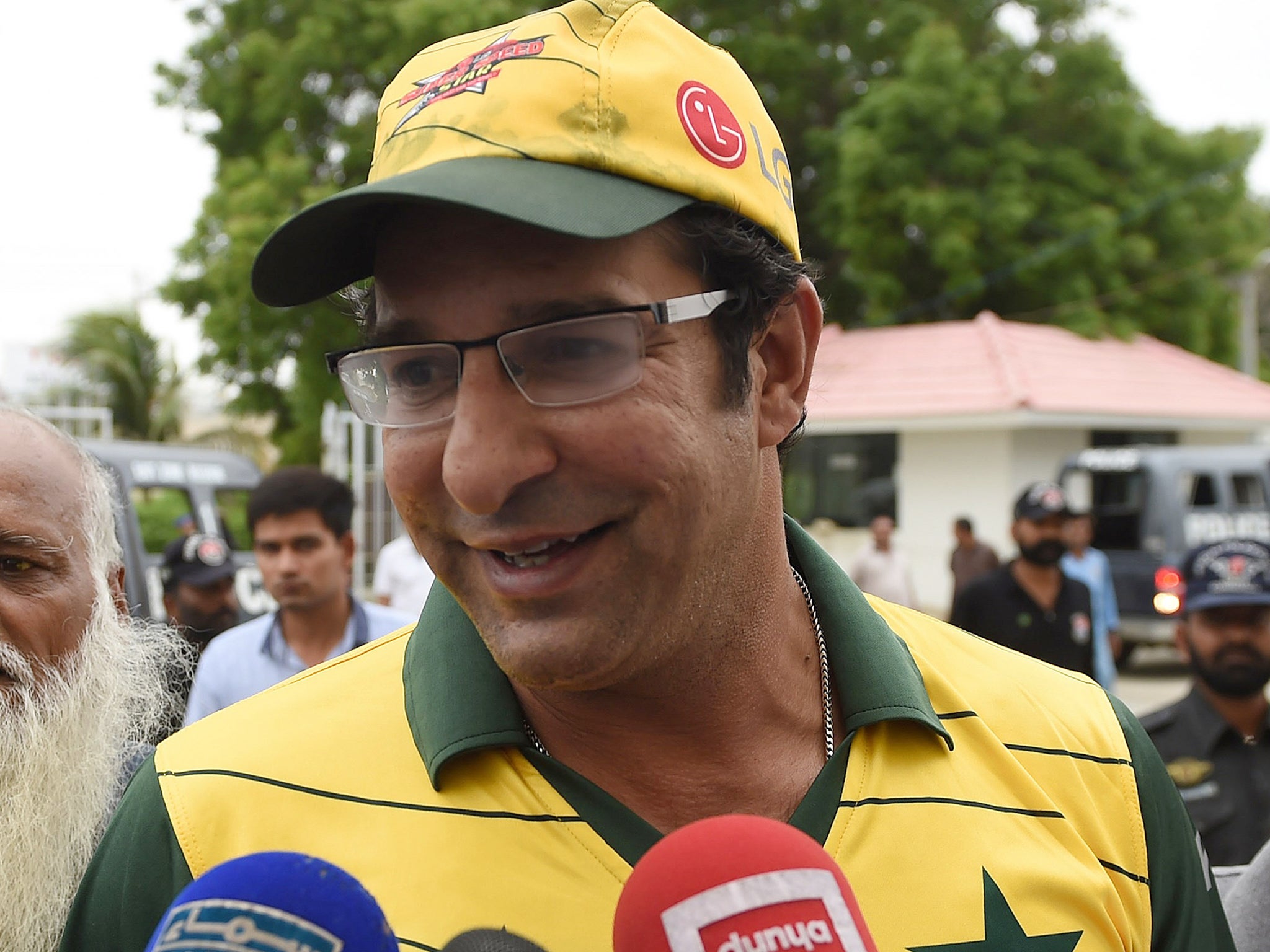 Pakistani former cricket captain Wasim Akram talks to media as he arrives at the National Cricket Stadium in Karachi. after a gunman opened fire on his car in the southern port city