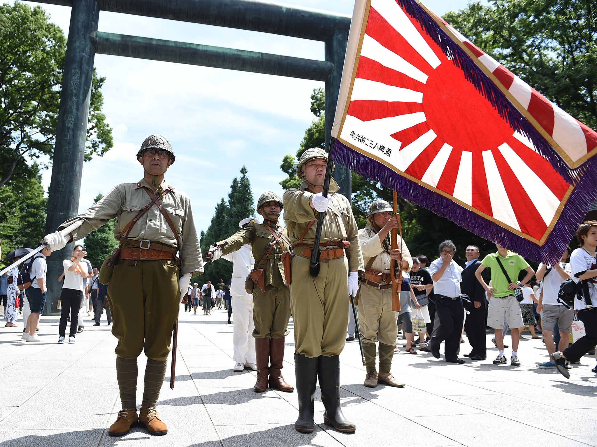 Men dressed in Second World War Japanese military uniform at the Yasukuni Shrine during the annual commemoration of Japan’s surrender (Getty)