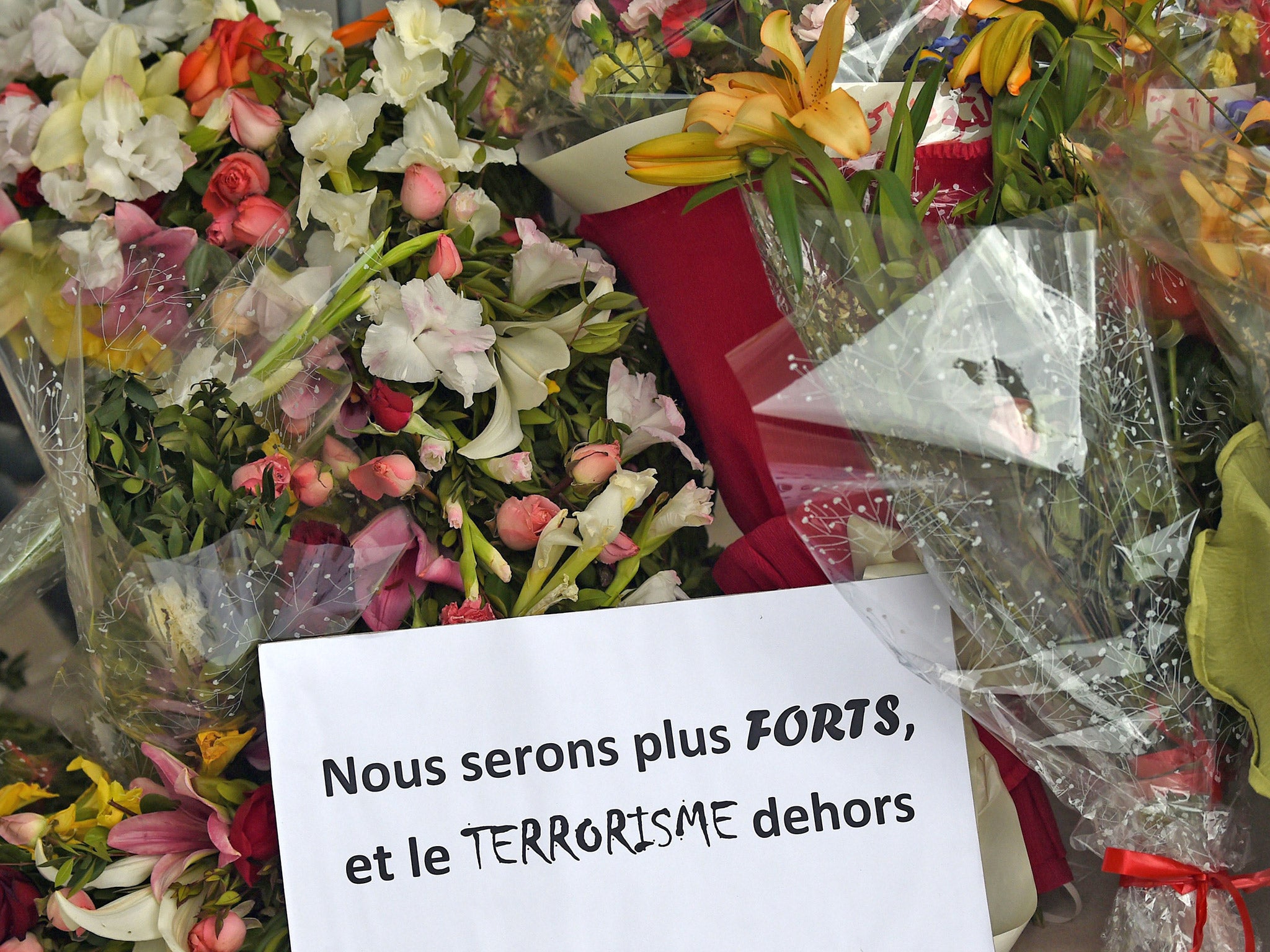 Flowers and a message reading in French: 'We will be stronger and and get rid of terrorism' laid outside the Bardo Museum following the attack in March (Getty)