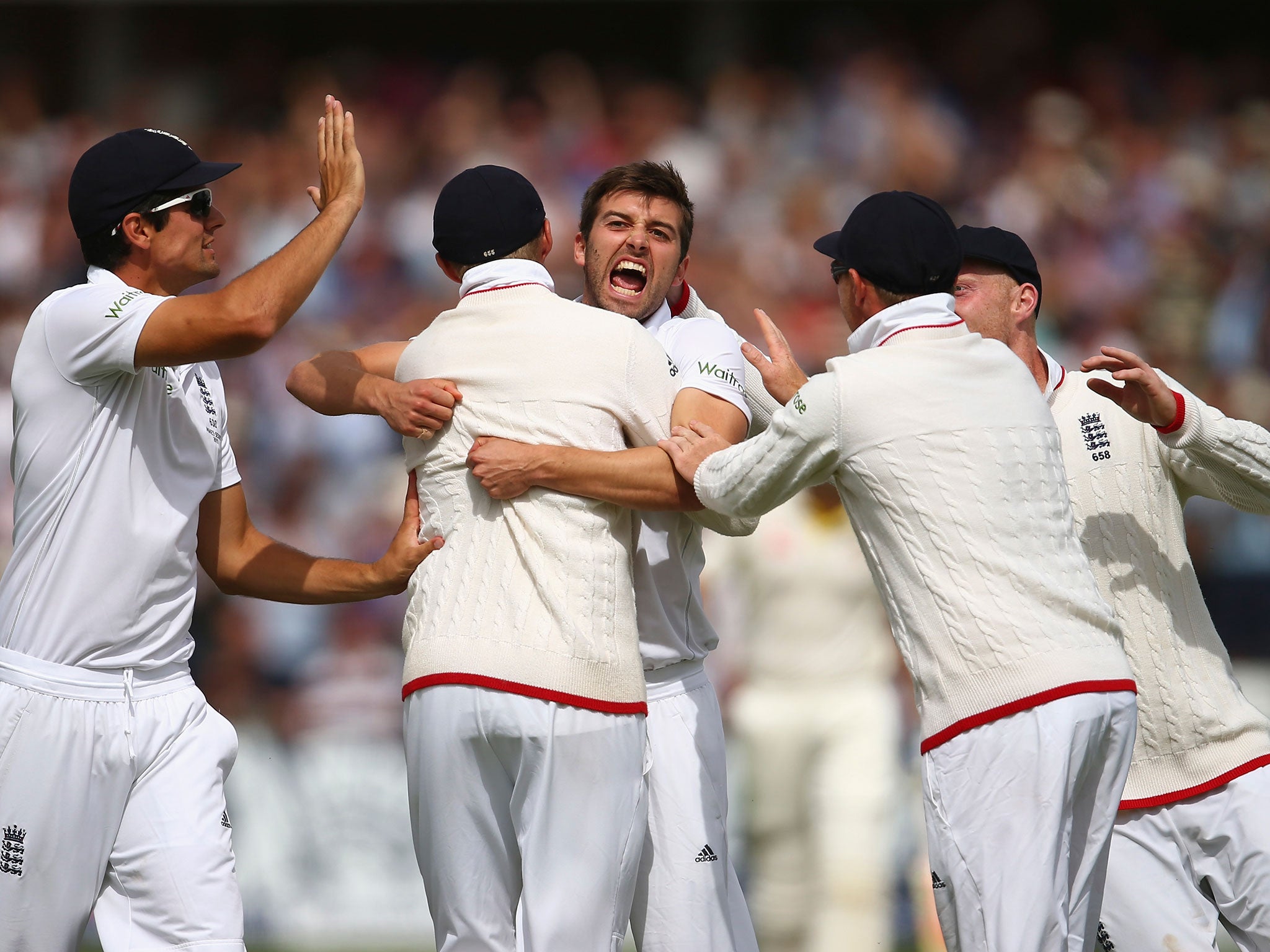 Mark Wood celebrates after taking the wicket of David Warner