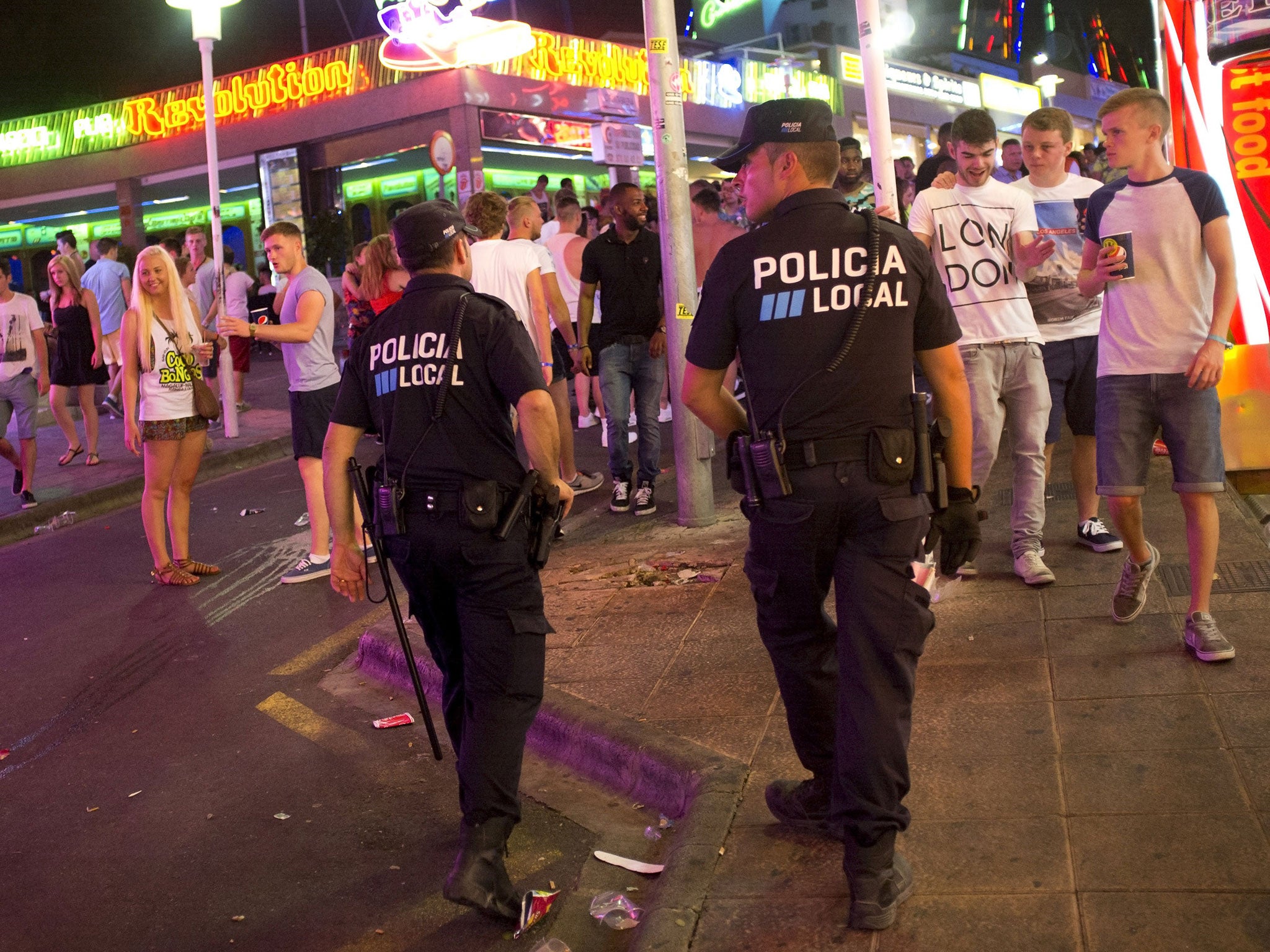 Two local policemen patrol in Punta Ballena street, in the Magalluf zone, in Calvia on Mallorca Island late on August 1, 2014