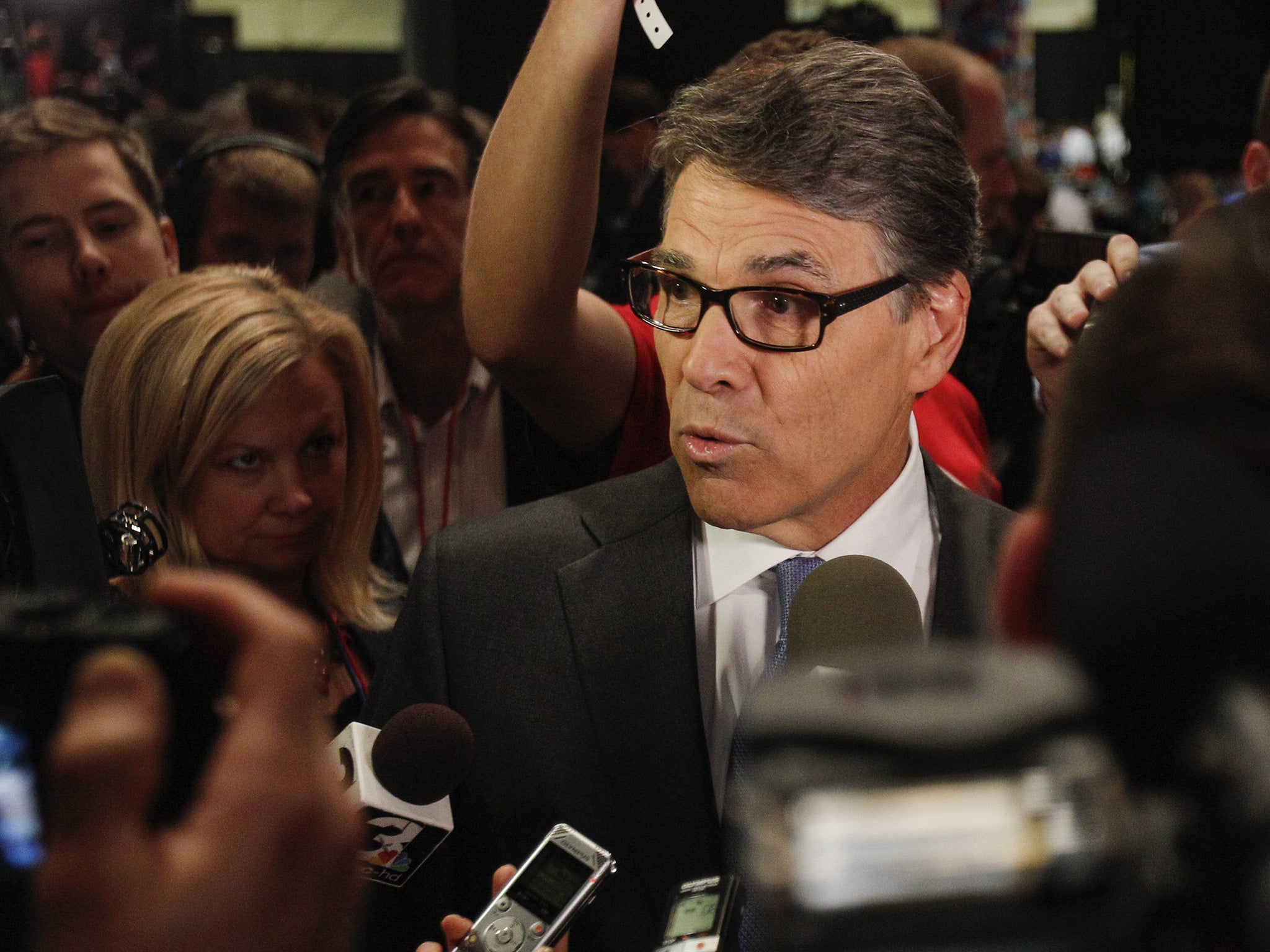 Rick Perry is questioned by journalists