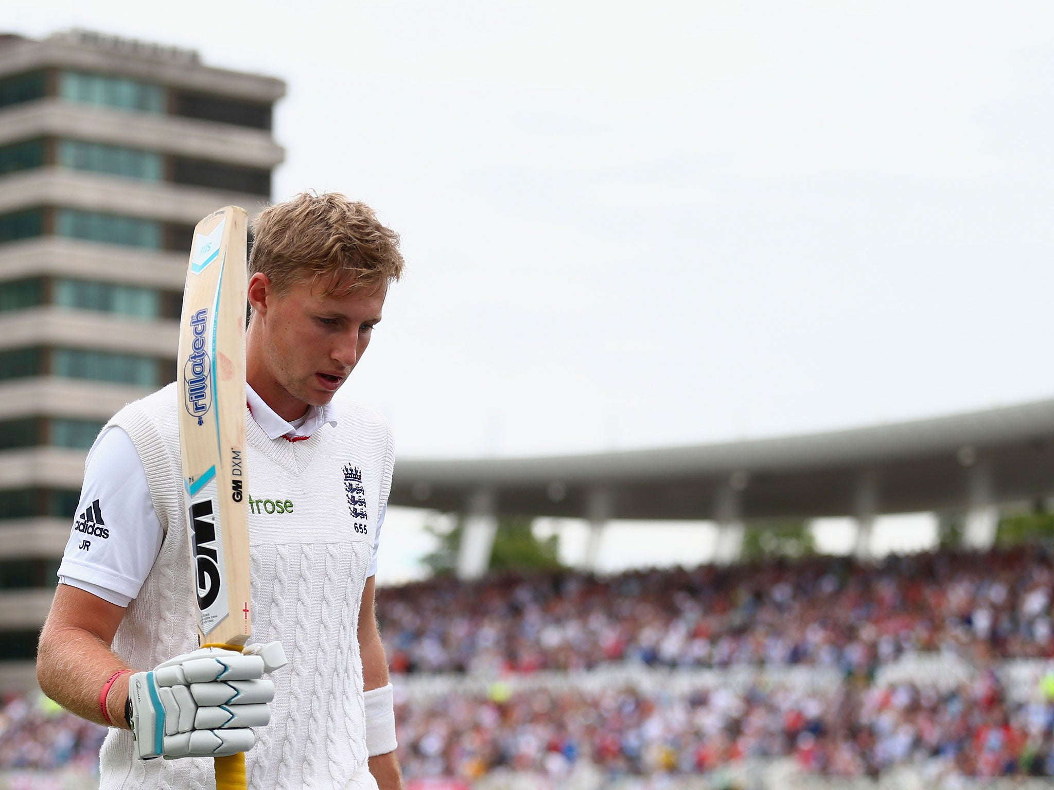 Joe Root of England raises his bat as he leave the ground after being dismissed for 130 runs by Mitchell Starc