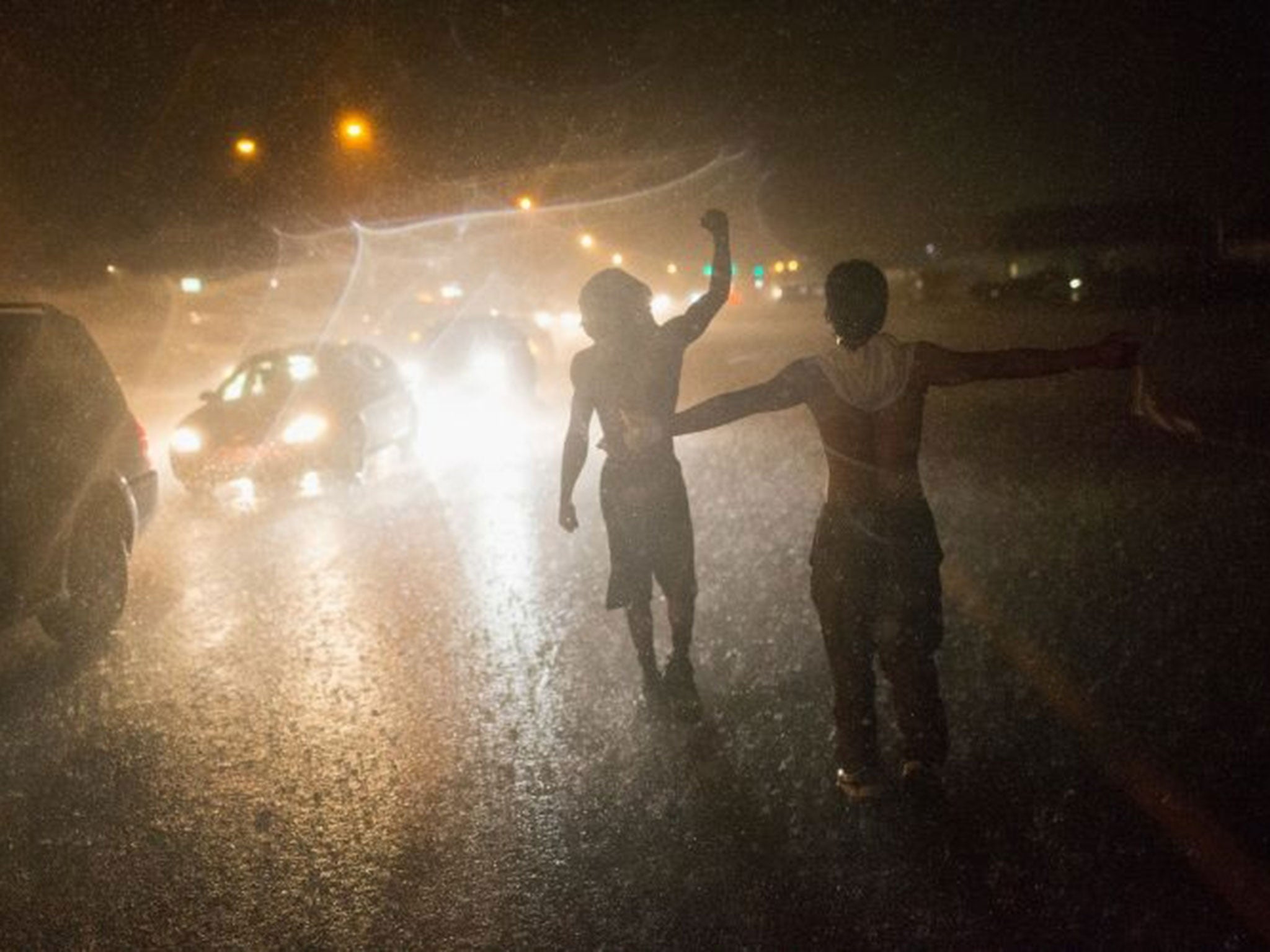 Demonstrators brave the rain on West Florrisant Avenue (Image: Scott Olson/Getty Images)