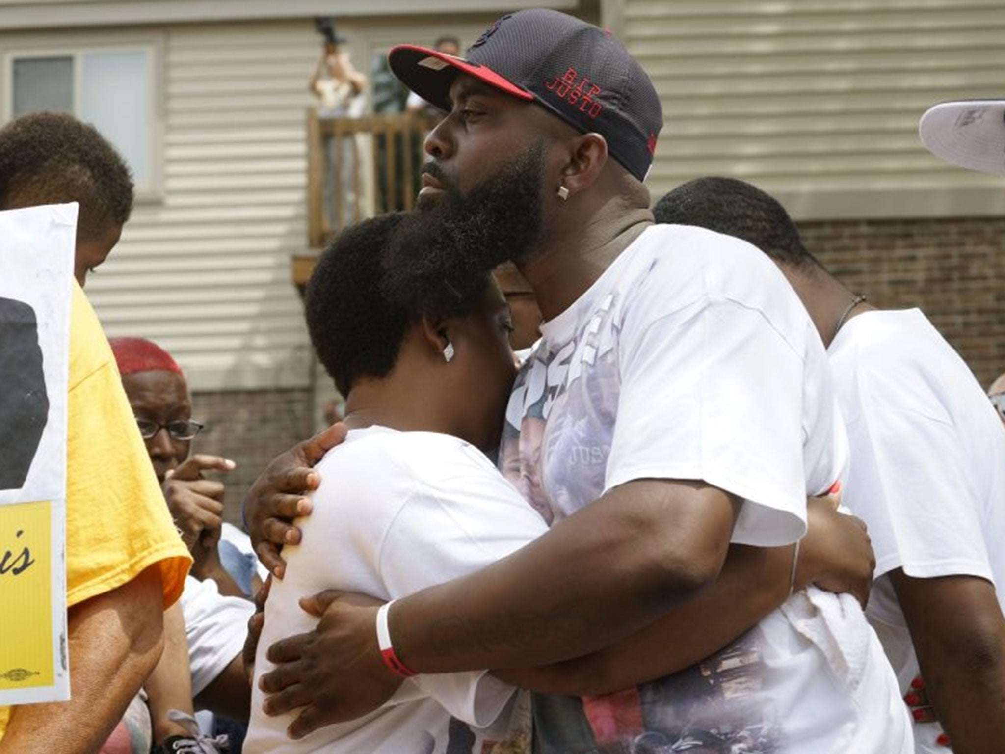 Michael Brown Sr., at the spot where his son was killed, comforts his wife Cal Brown in 2015