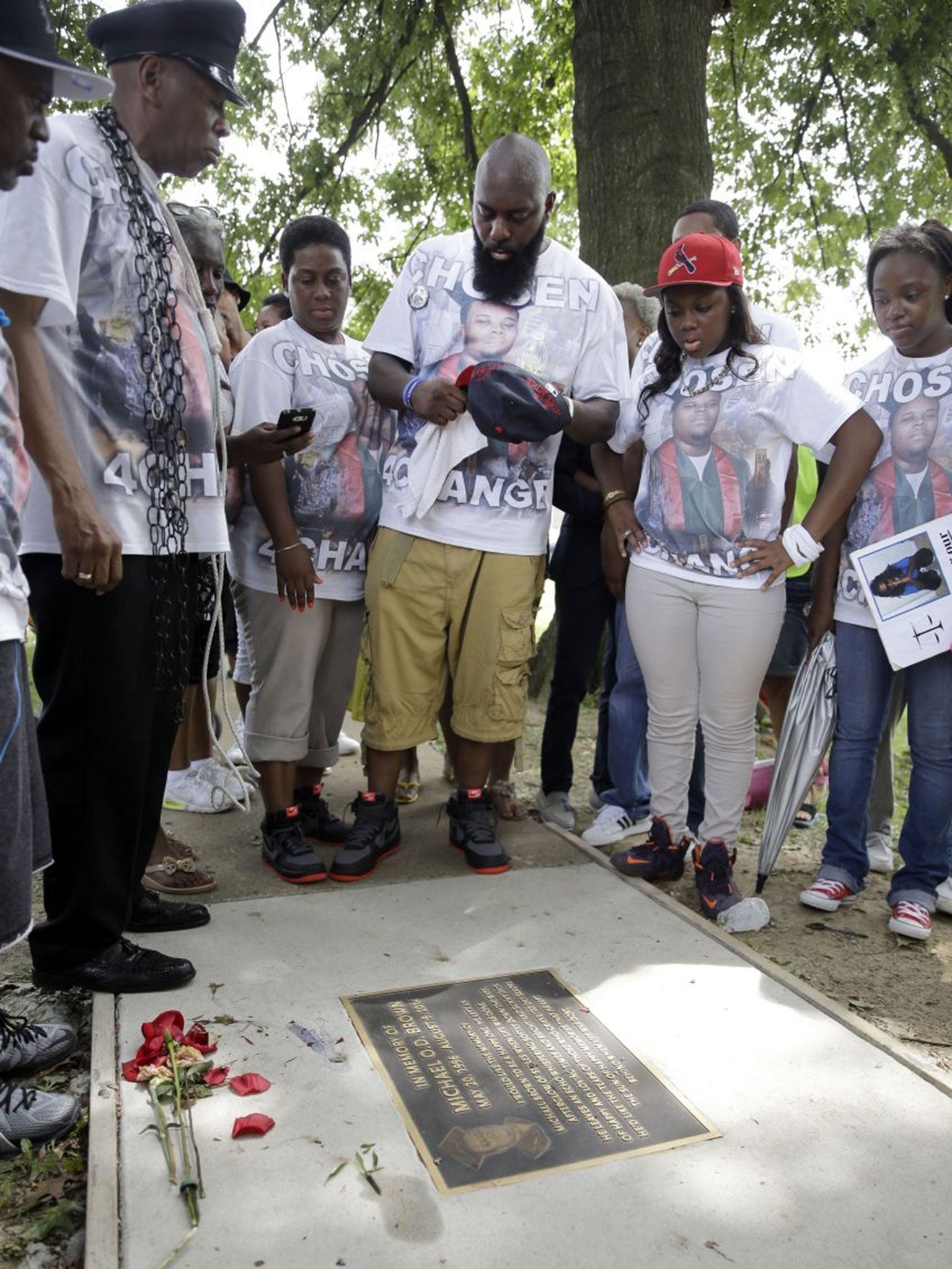 Michael Brown Sr stands at a memorial placed where his son died (Image: AP Photo/Jeff Roberson)