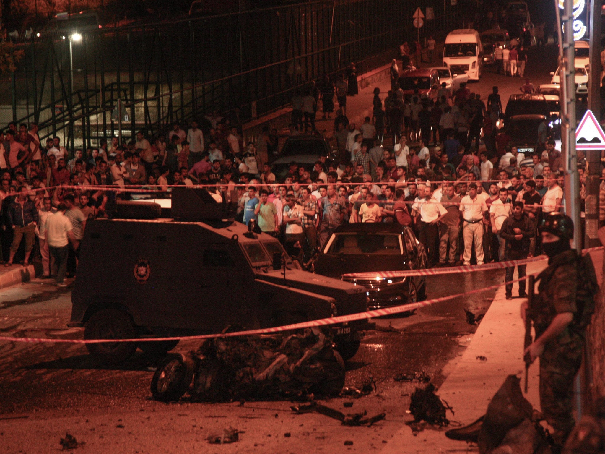 Member of Turkish SWAT team stand near destroyed cars after a explosion.