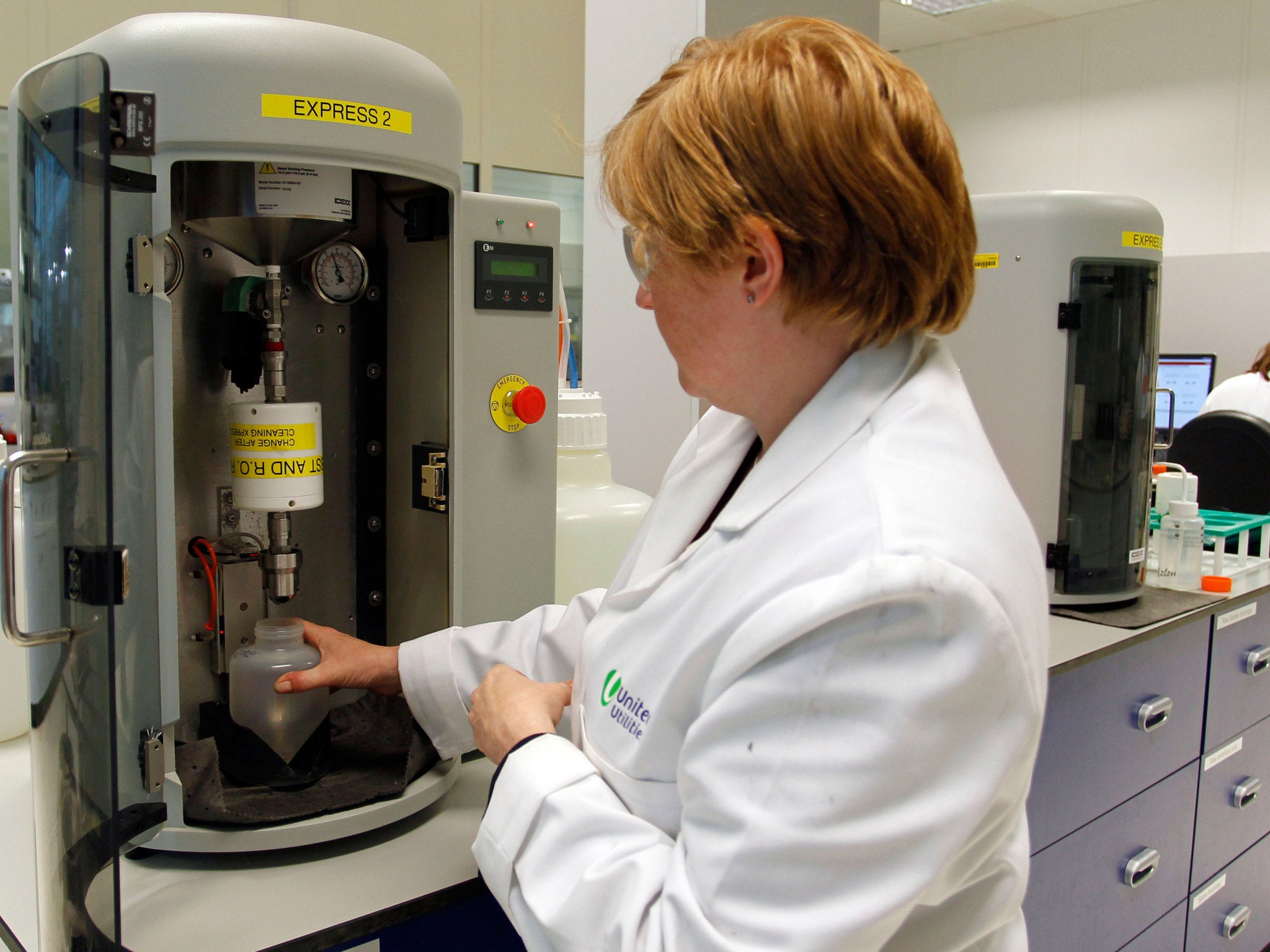 Technician tests a sample of water at a United Utilities laboratory in Warrington