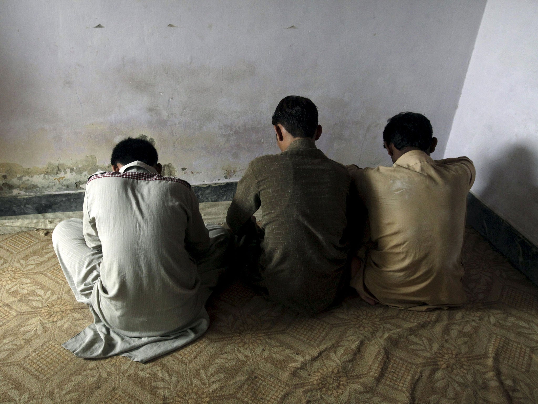 Children whose families say have been abused, turn their backs to the camera while they are interviewed by a Reuters correspondent in their village of Husain Khan Wala