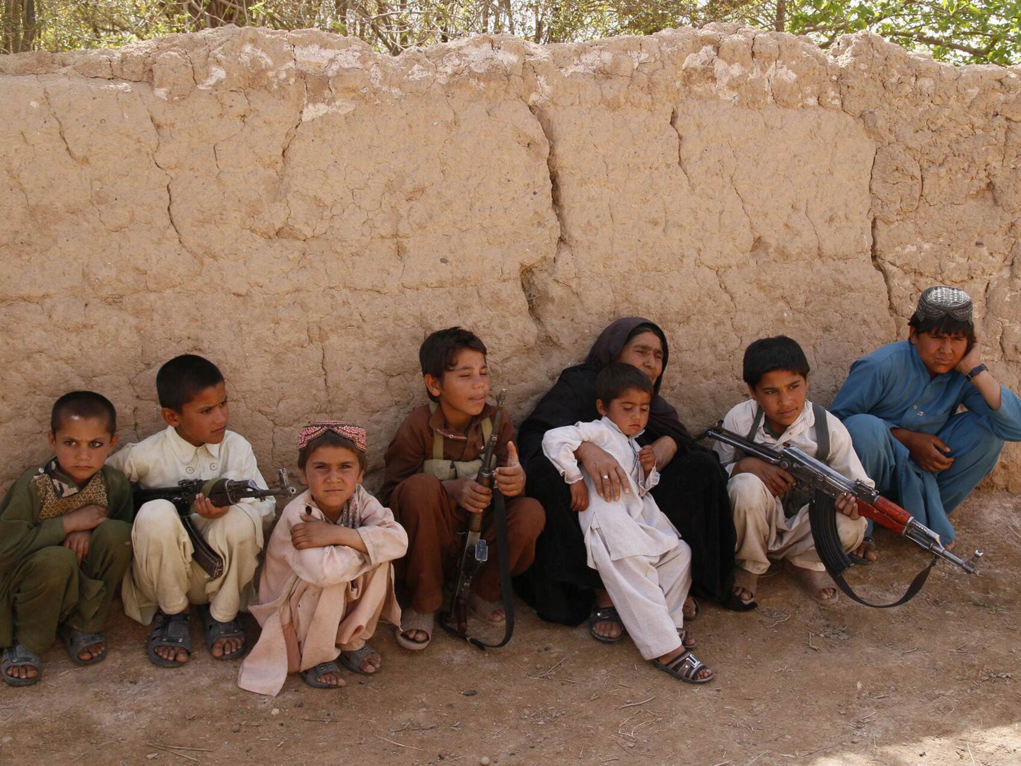 Feroza, 53, the only female police commander in Afghanistan, with her grandchildren, who fight for her