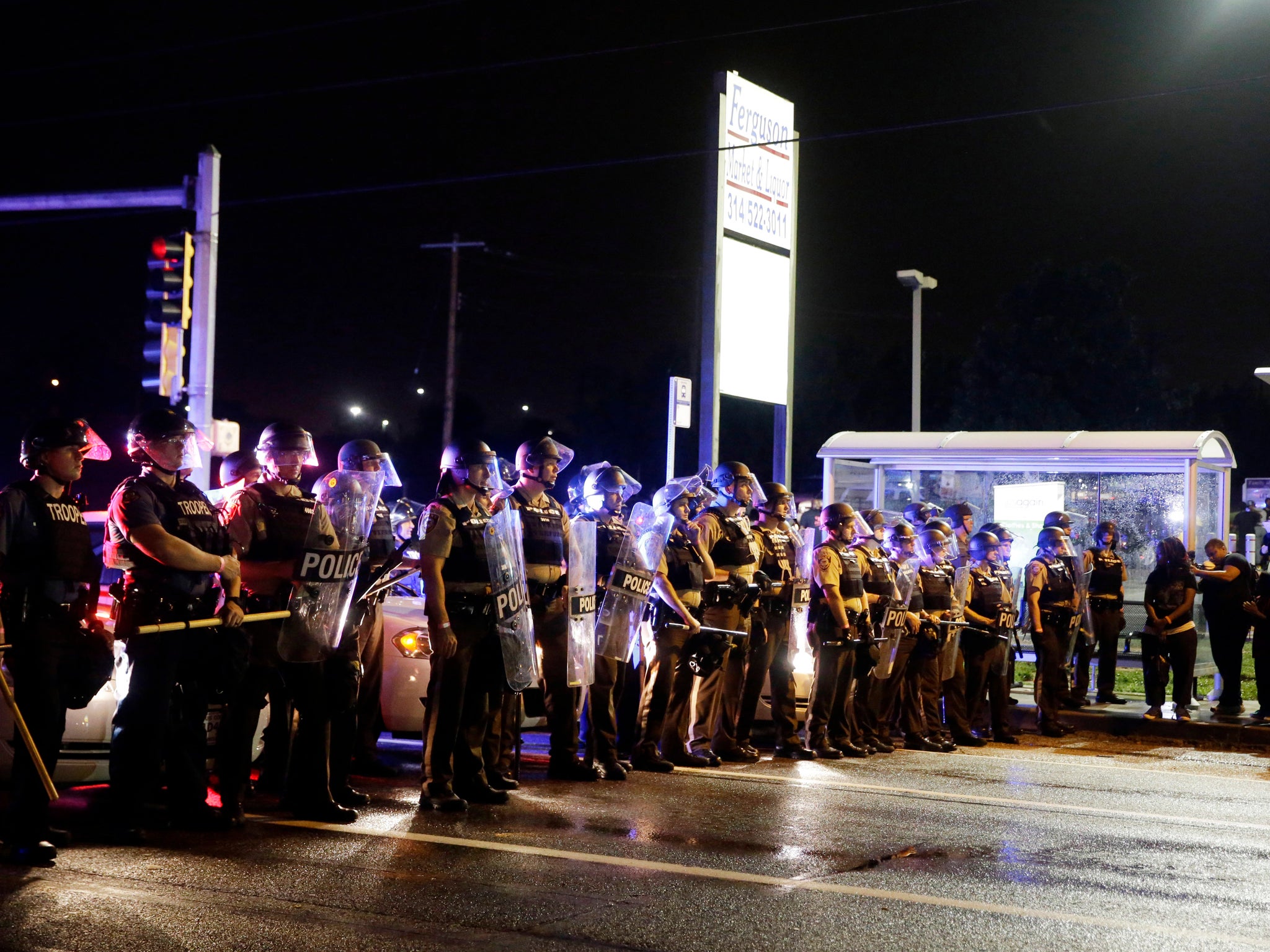 Officers with riot shields lined up on West Florissant Ave. In Ferguson Mo