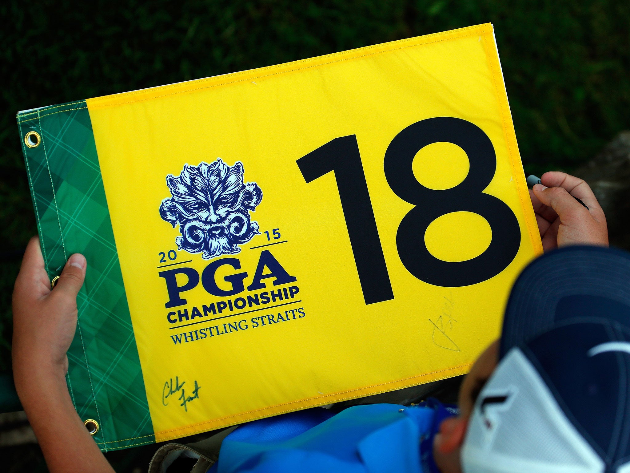 A fan waits for autographs during a practice round prior to the 2015 PGA Championship at Whistling Straits