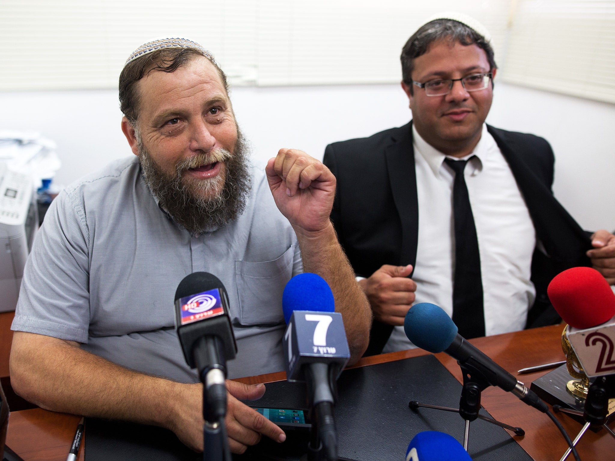 Leader of the extreme right-wing movement Lehava, Benzi Gopstein, talks to journalists after he was questioned by Israeli police on Tuesday (Getty)