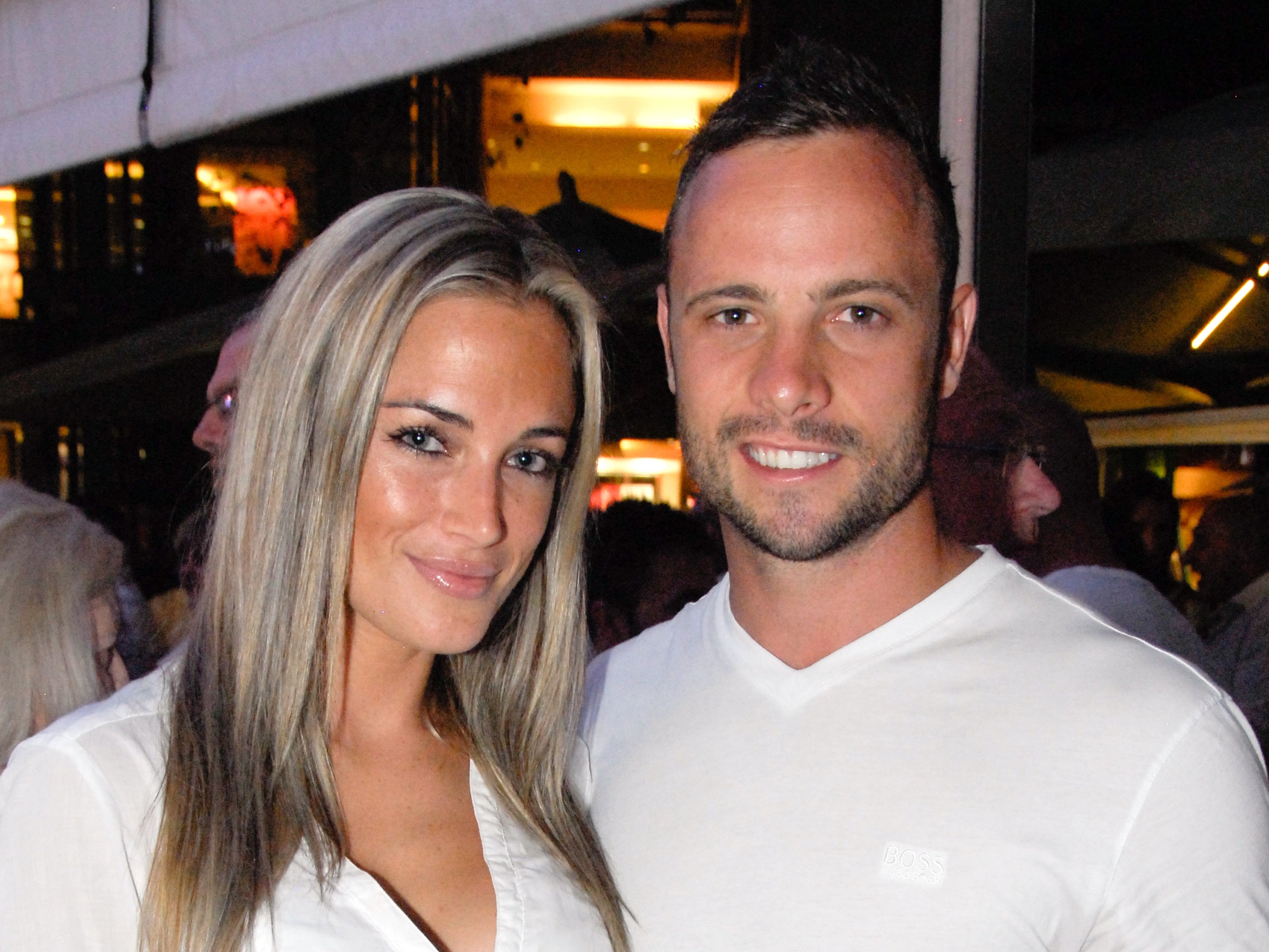 A picture taken on January 26, 2013 shows Olympian sprinter Oscar Pistorius posing next to his girlfriend Reeva Steenkamp - 3 weeks later Pistorius was taken into police custody.