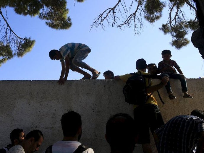 Migrants were injured trying to climb over the stadium's wall to get food and water