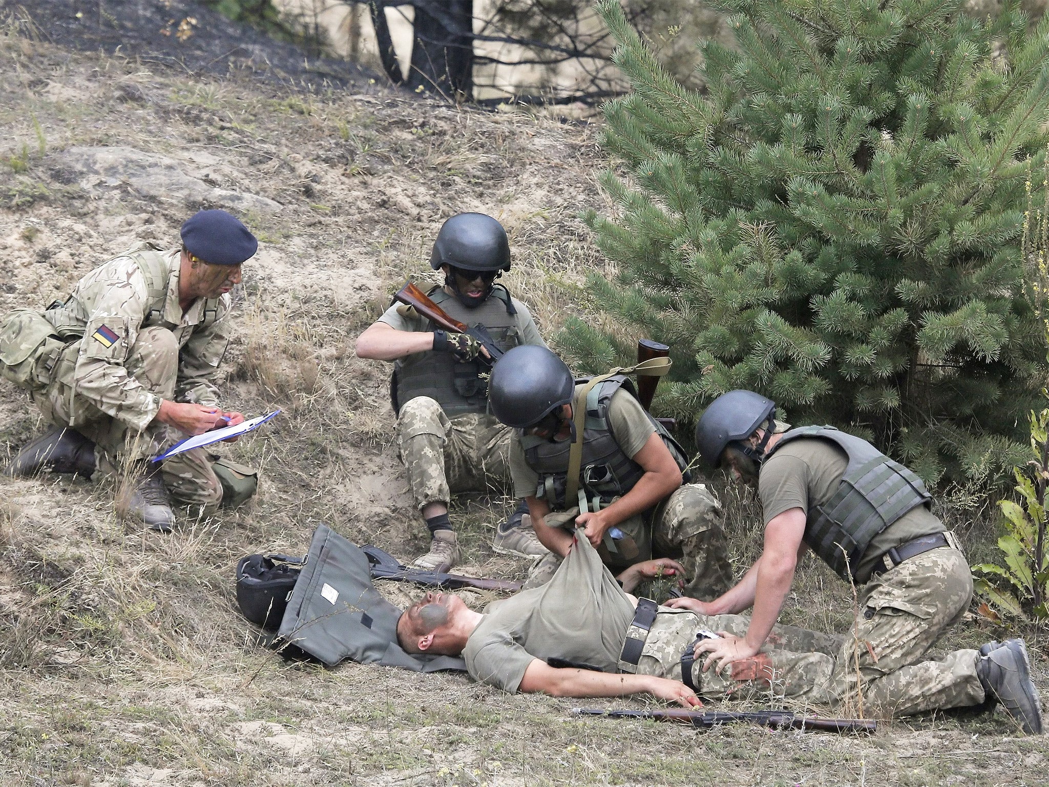 Ukrainian soldiers and their British instructor (left) during a training session at the Perlyavka shooting range near Zhytomir, Ukraine