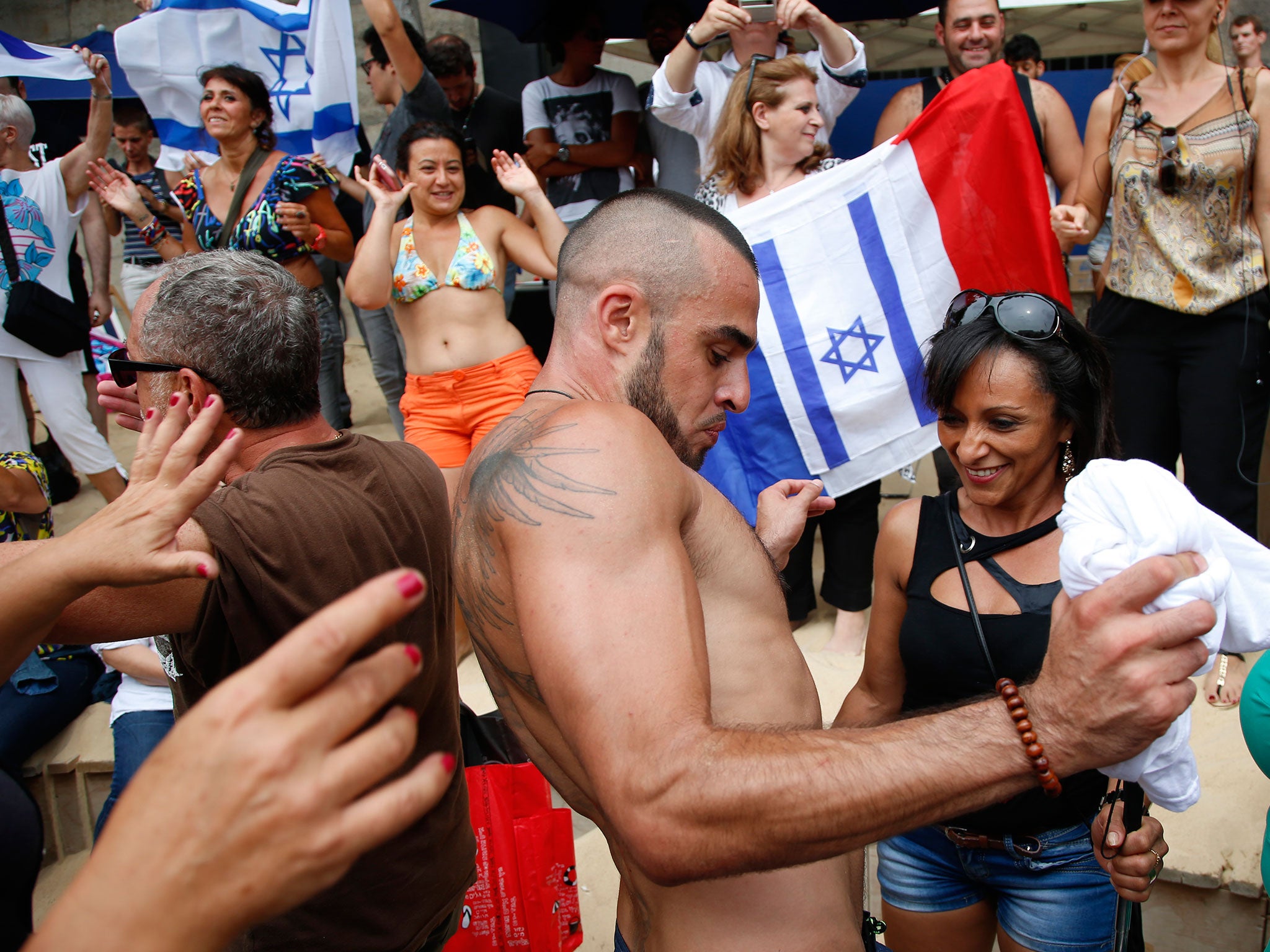 Visitors dance on the beach