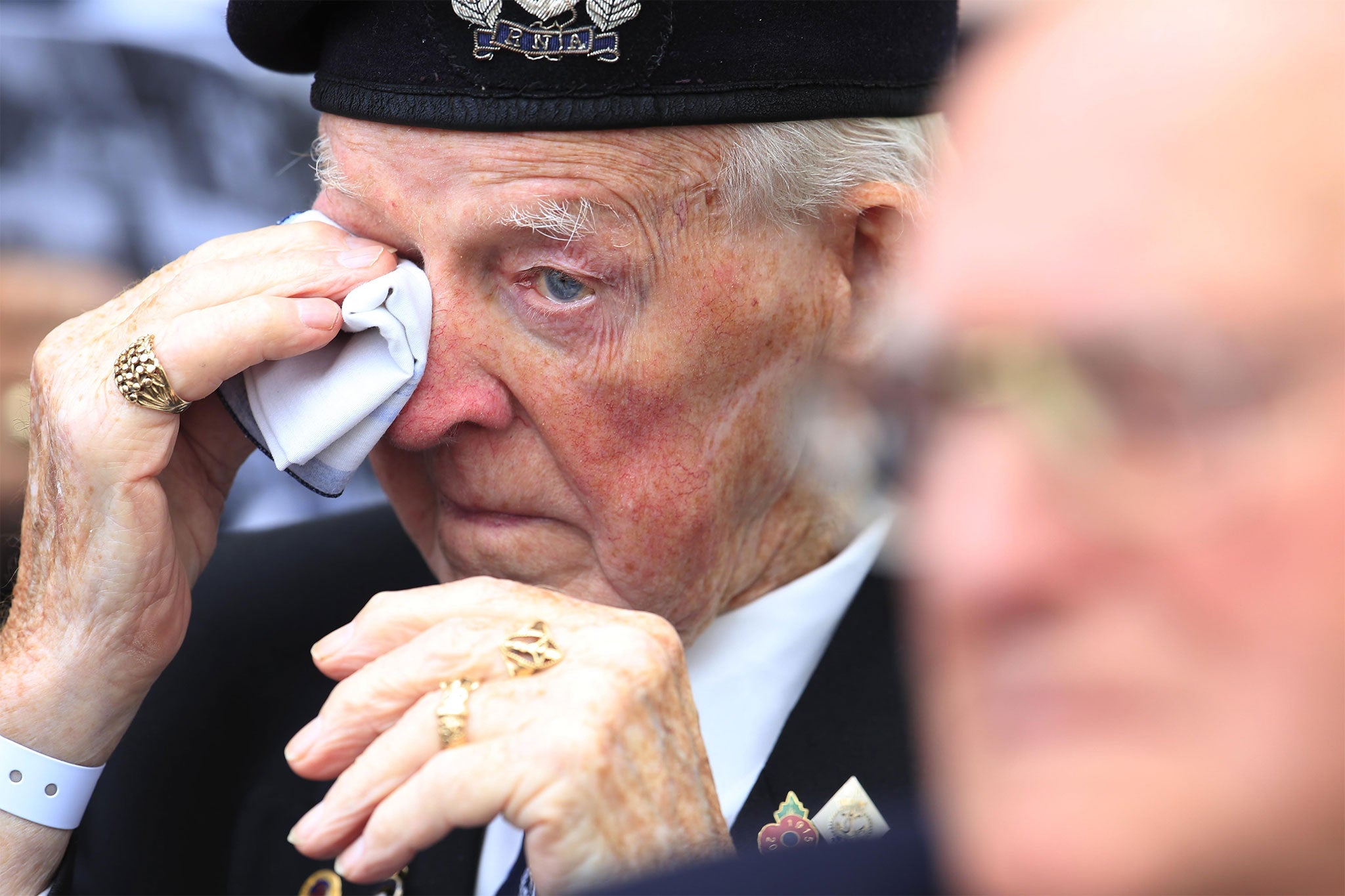 A veteran wipes away a tear during commemorations