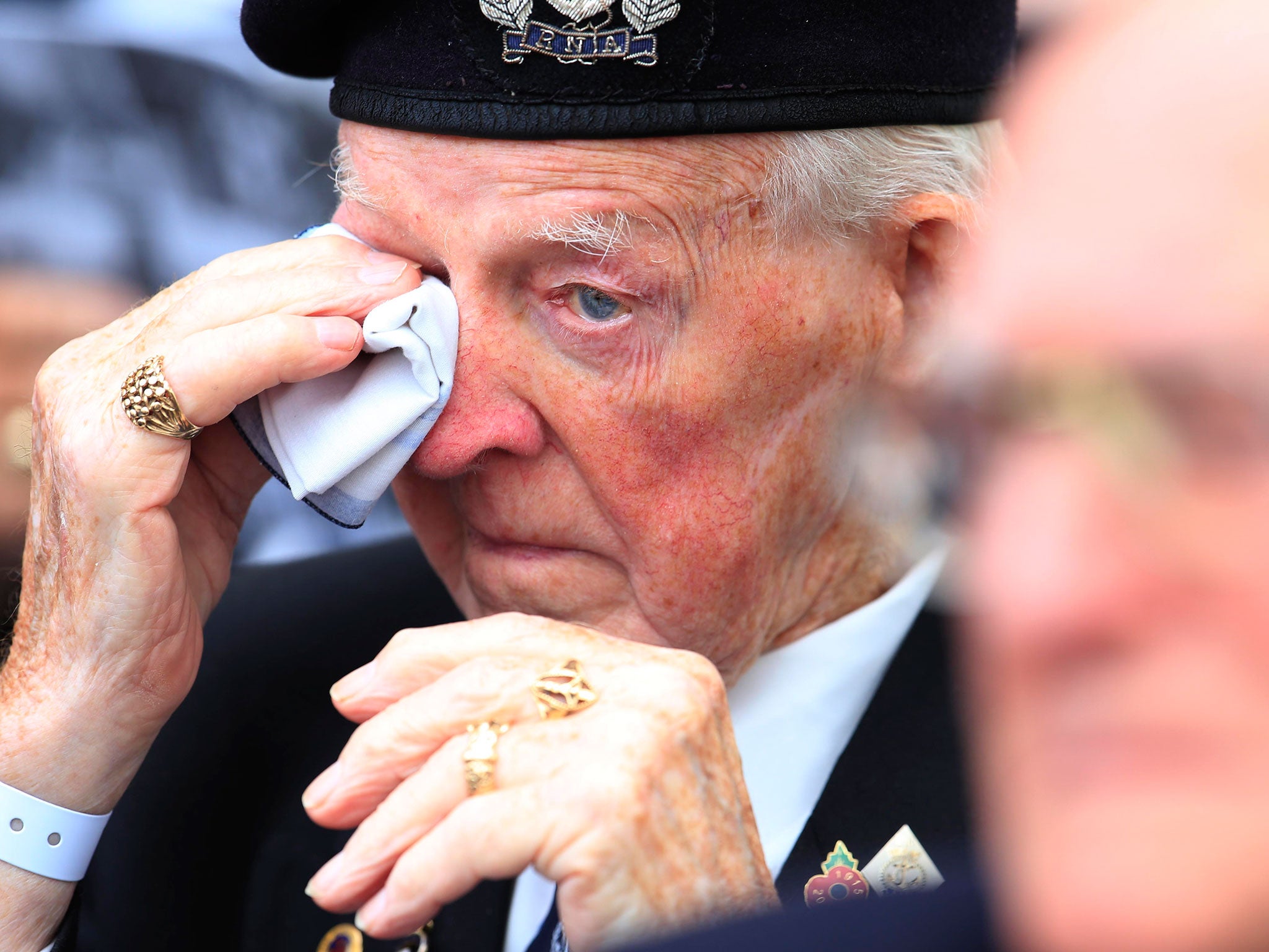 A veteran wipes away a tear