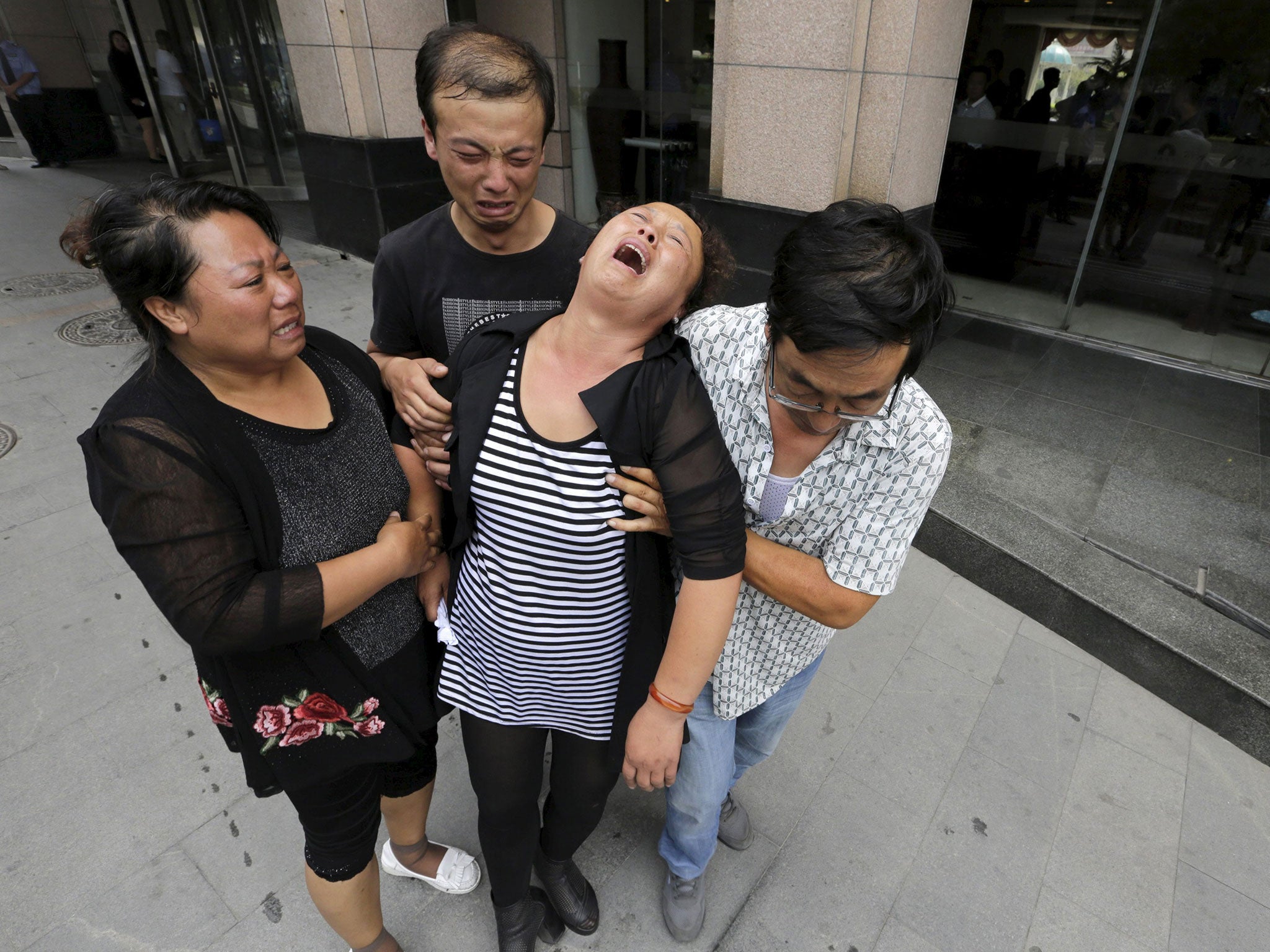 The mother of a missing firefighter weeps