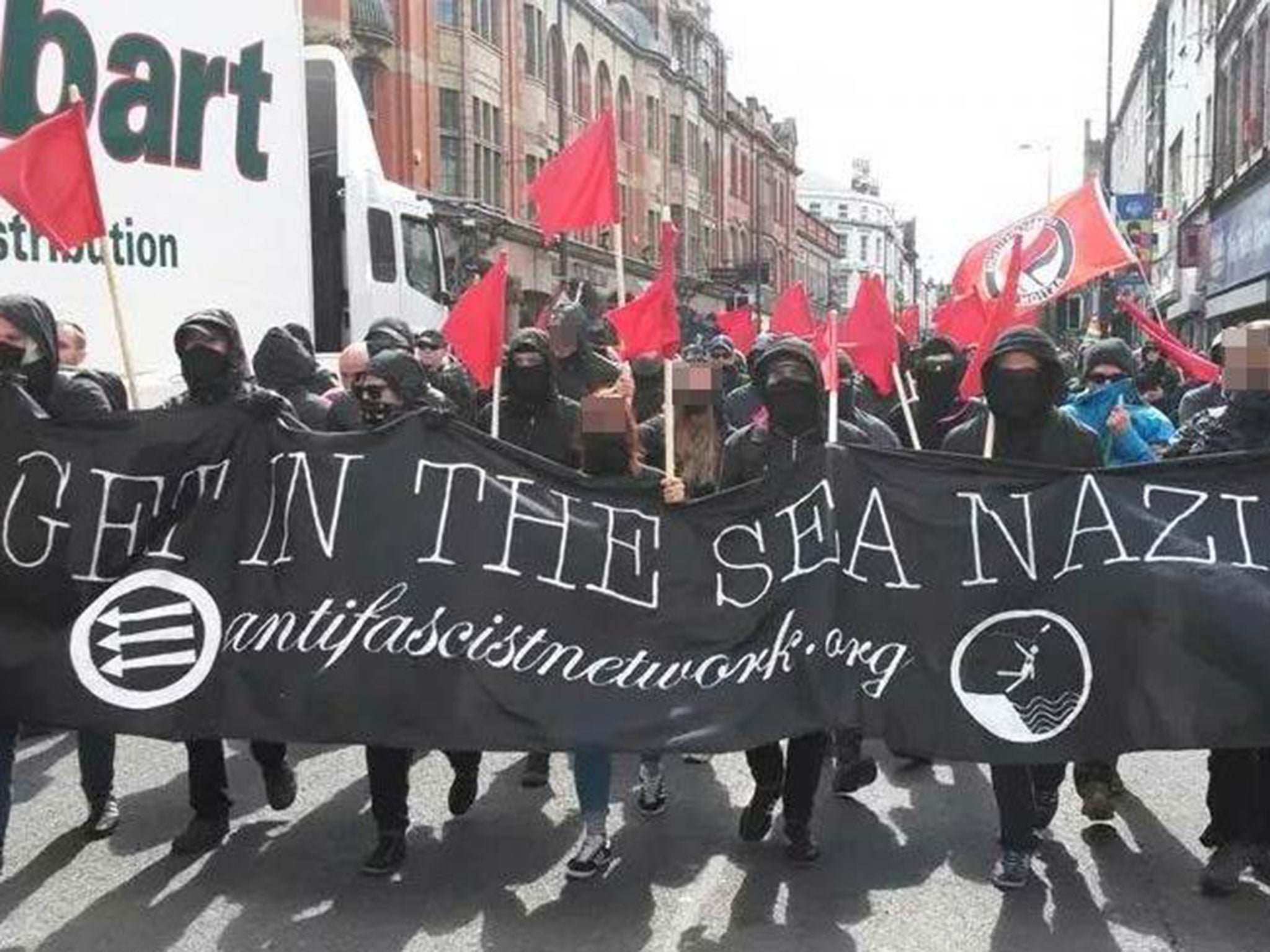 Anti-Fascism protesters carry a banner through Liverpool which reads 'Get in the sea, Nazis'