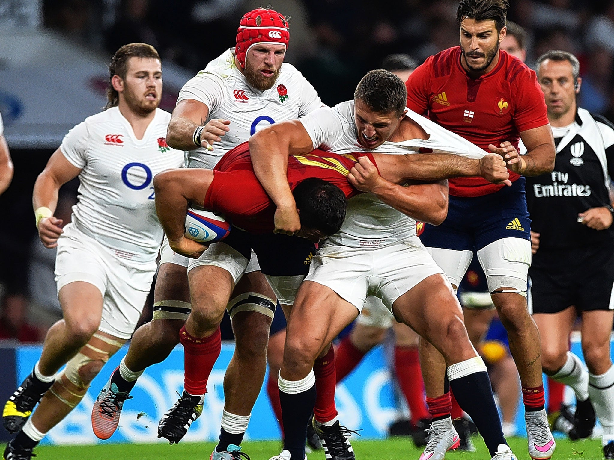 Sam Burgess wrestles France’s Guilhem Guirado to the ground