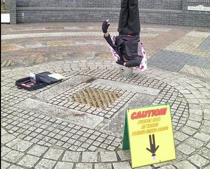 Travis could be seen in Plymouth city centre posing as the 'bucket man'