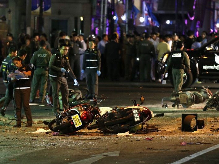 Motorcycles lie on the street at the scene of a bomb attack near Erawan Shrine, central Bangkok, Thailand, 17 August 2015.